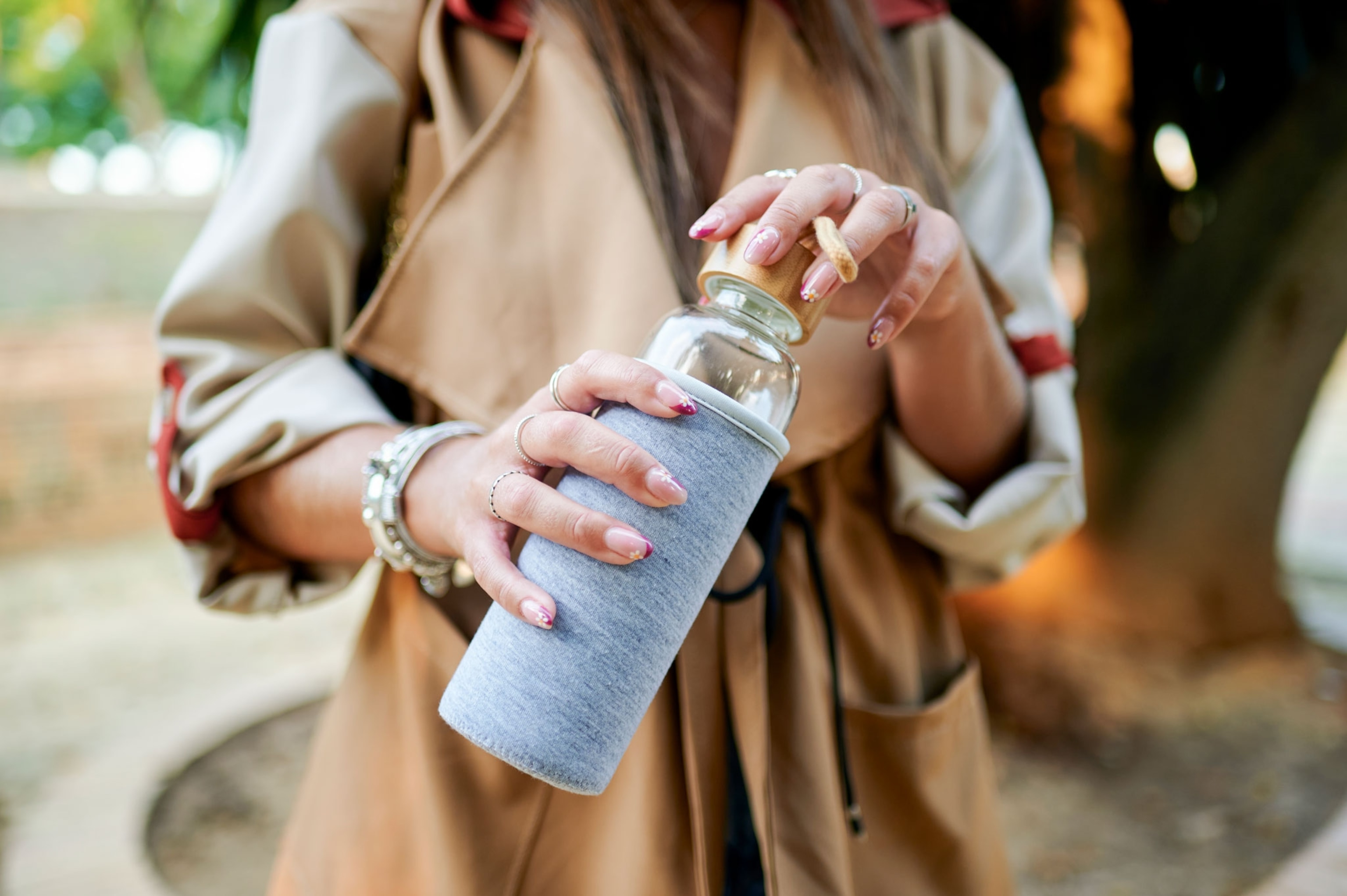 Woman holding reusable glass bottle