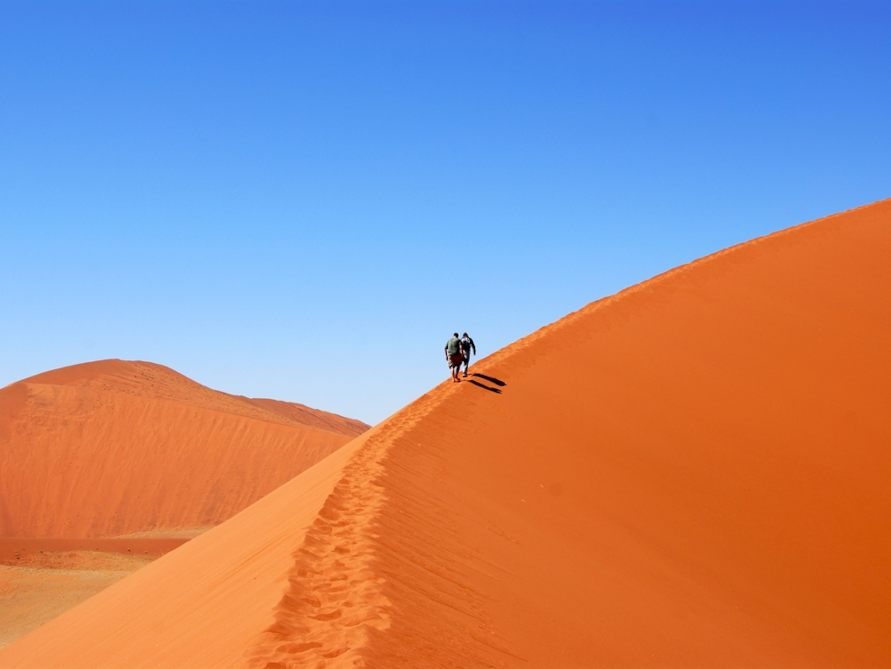 Hikers on a sand dune