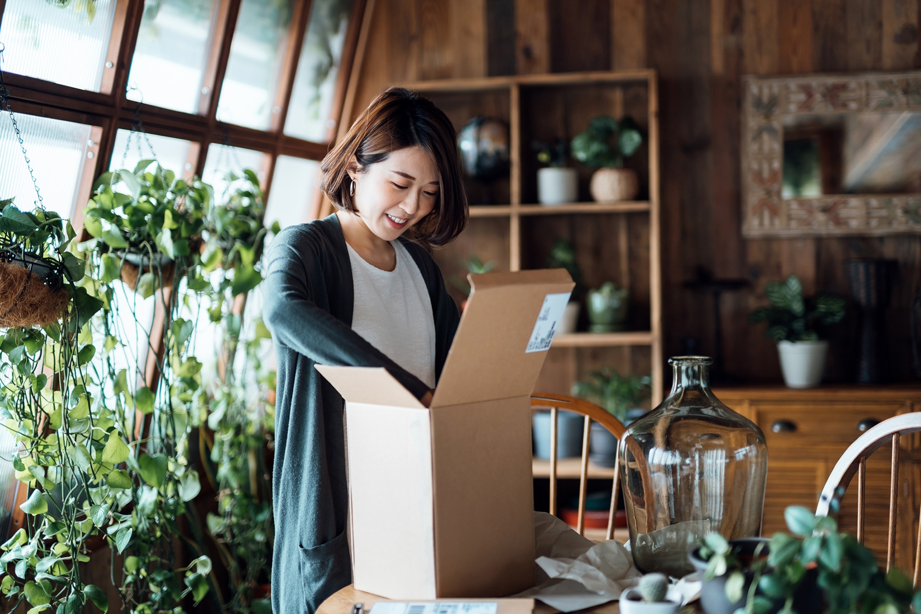 A woman unboxes a delivered package.