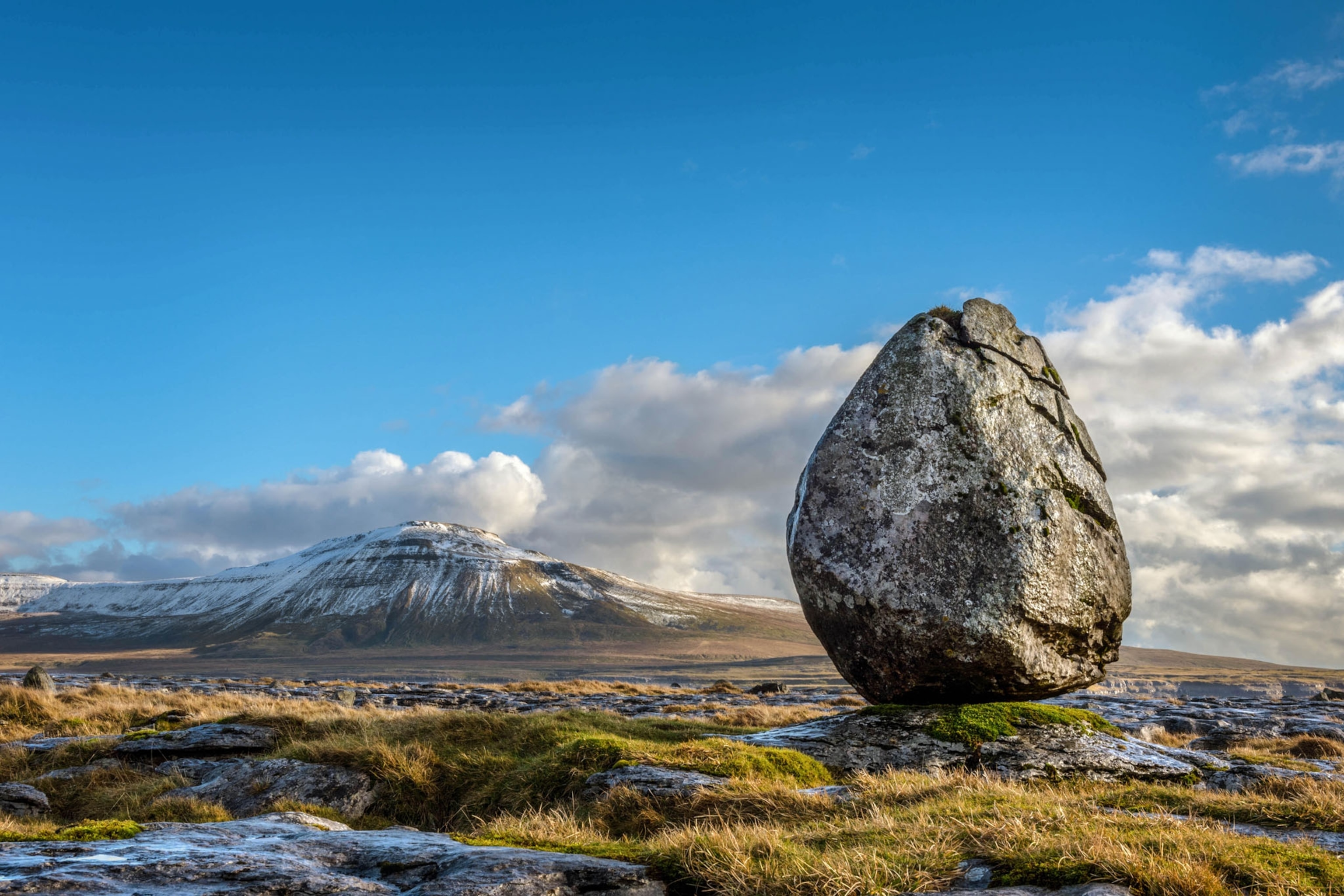 Picture of huge egg-shaped boulder standing vertically.