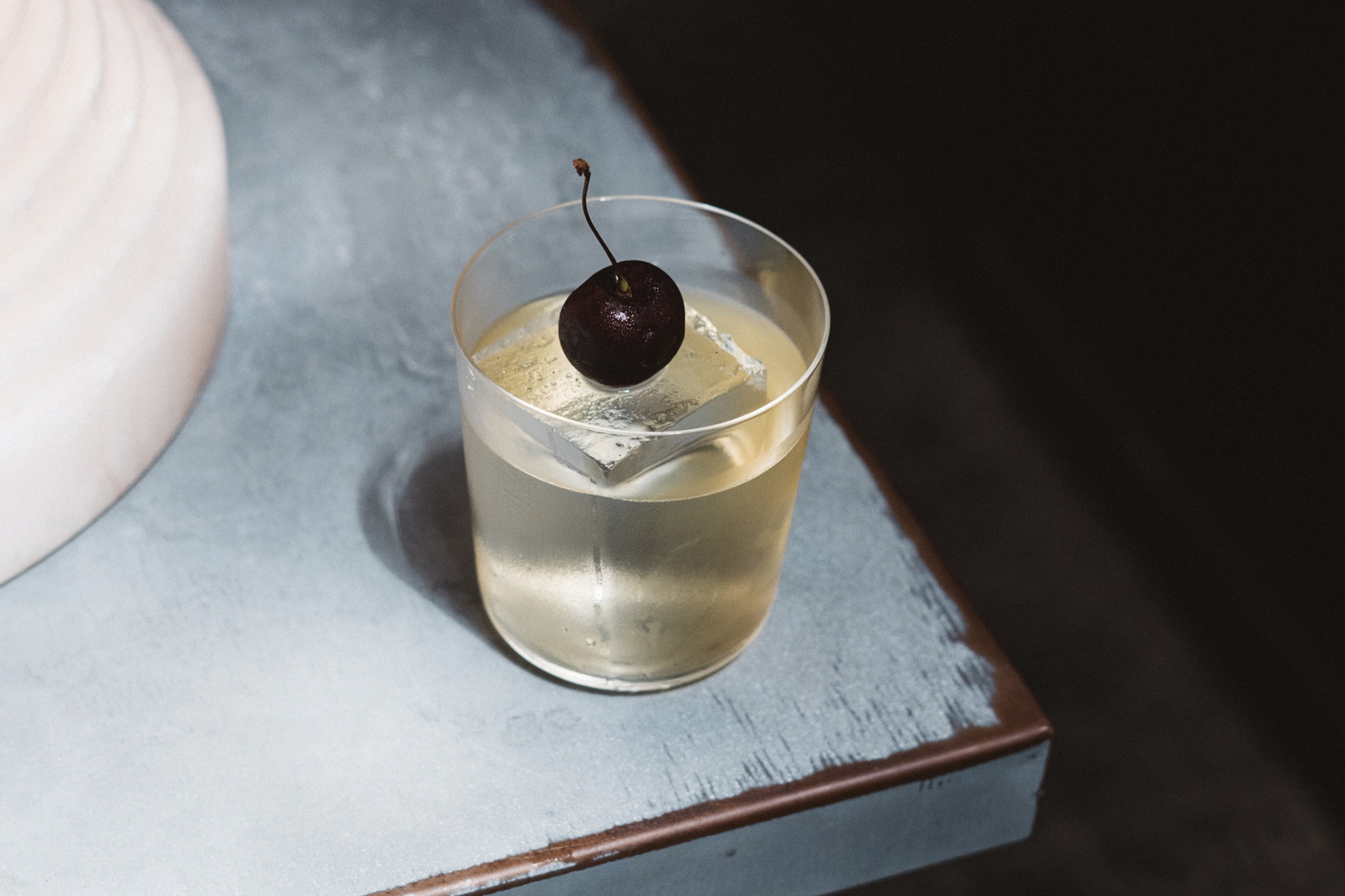 A cocktail with a cherry.
