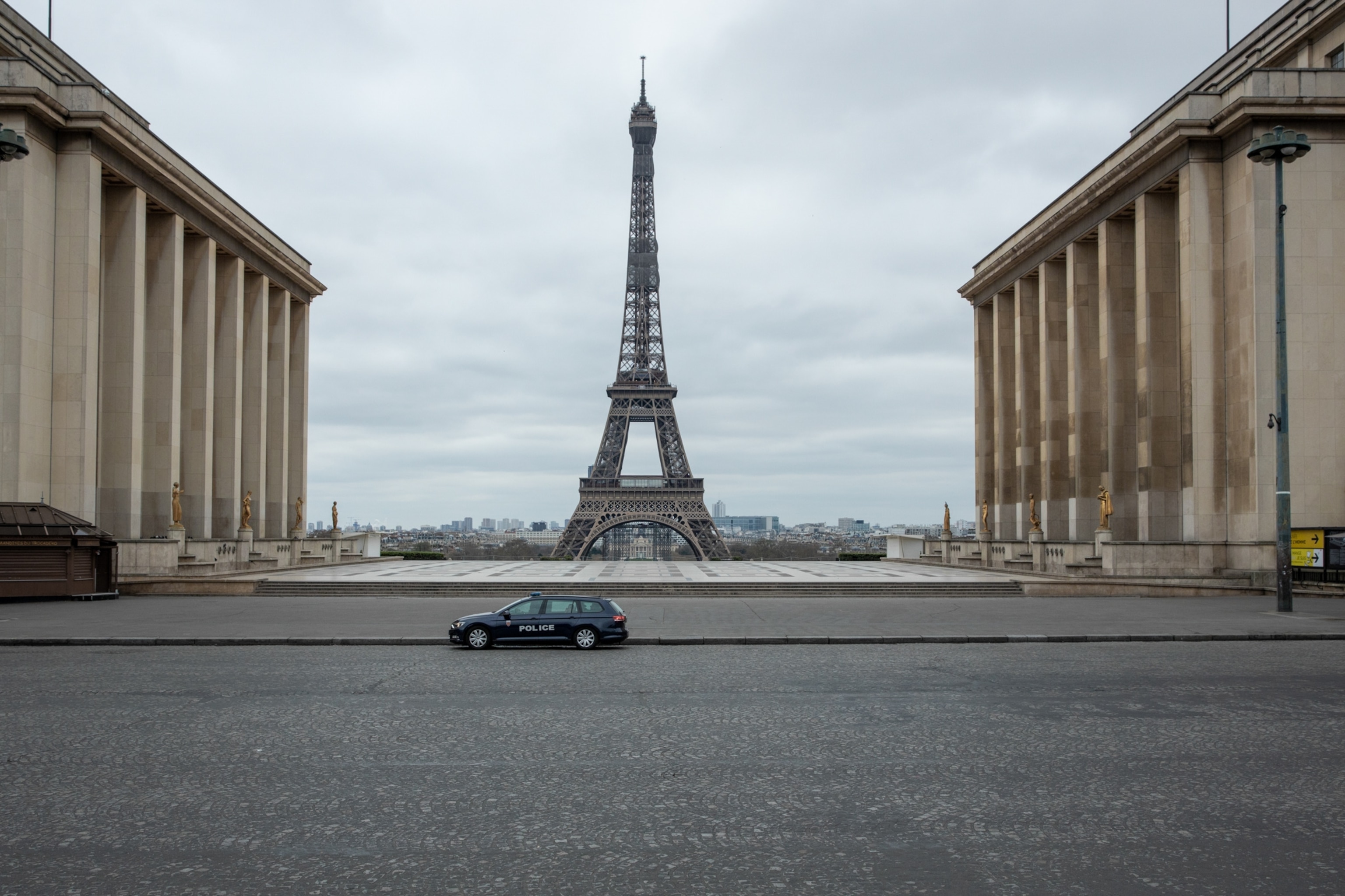 a police car with the Eiffel tower in the background