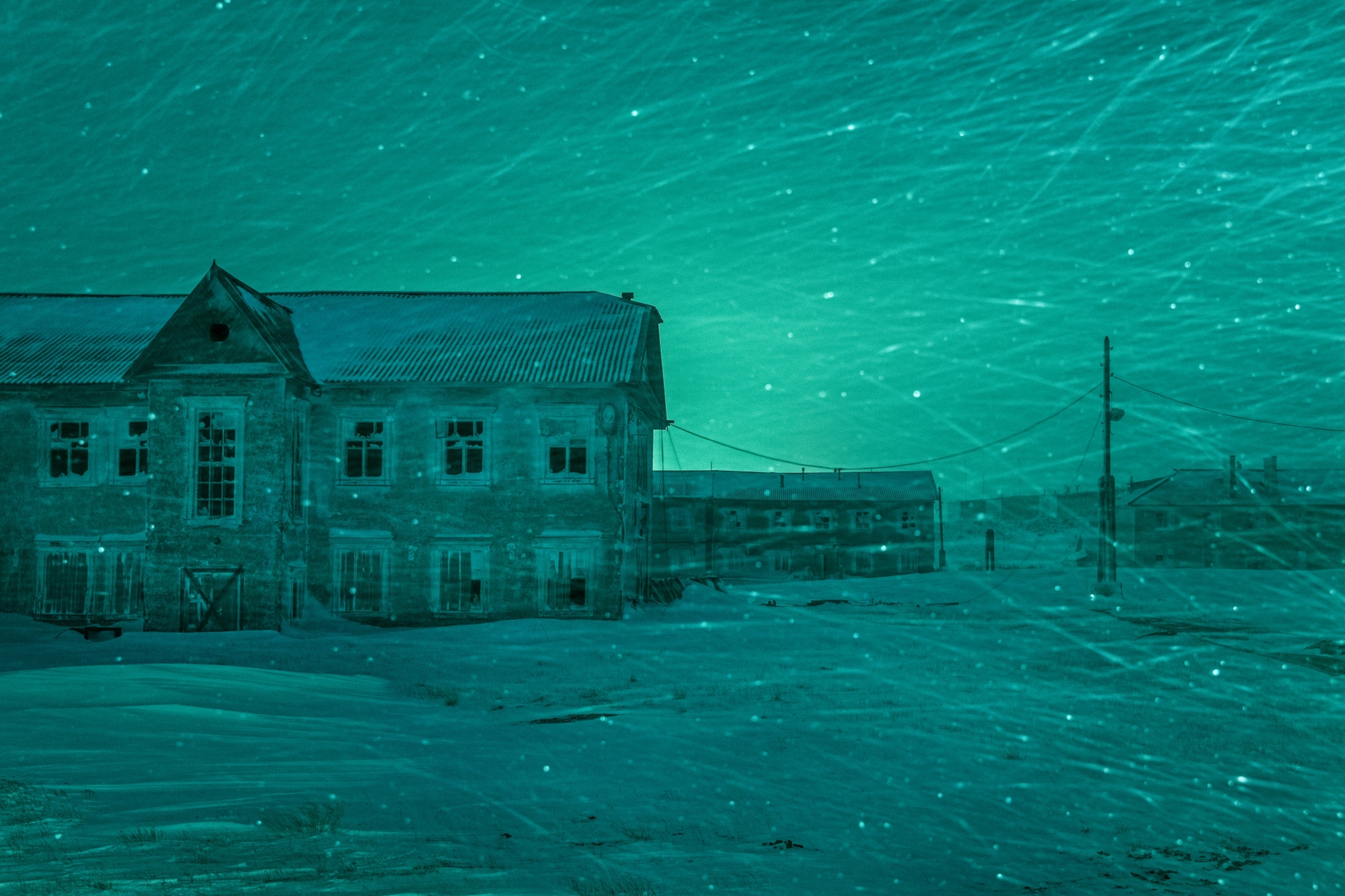 abandoned building with Aurora Borealis above it.