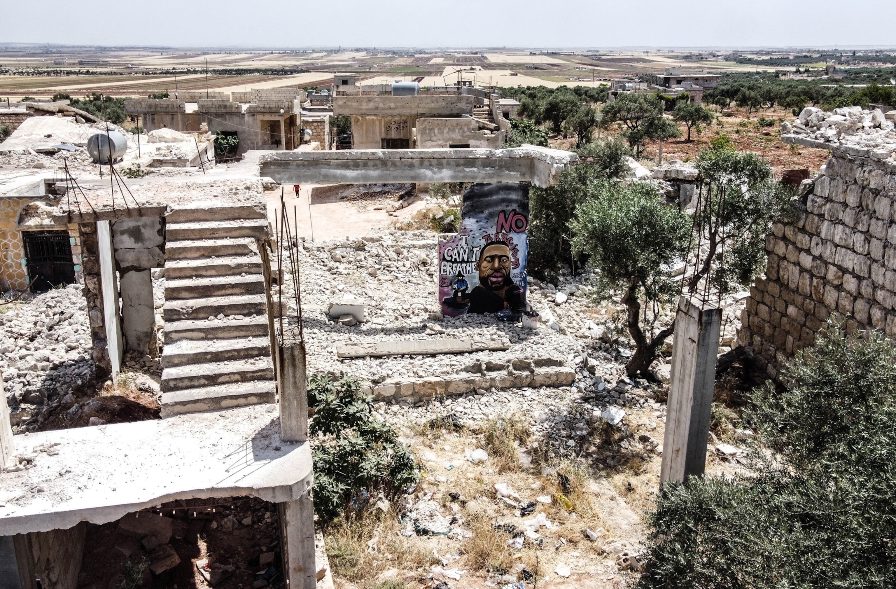 a mural of George Floyd on a wall in syria
