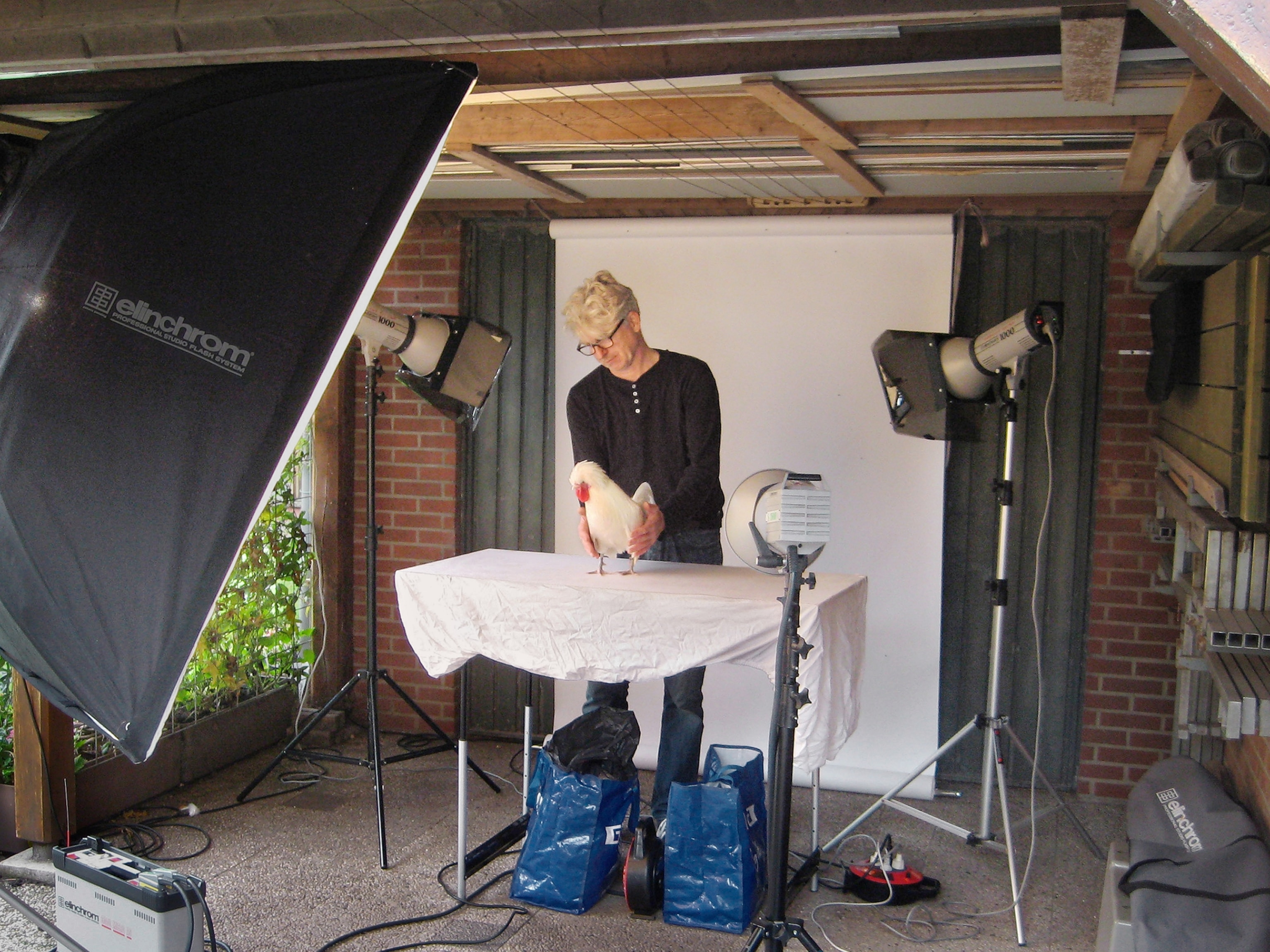 Picture of Alex ten Napel in studio preparing chicken to be photographed.