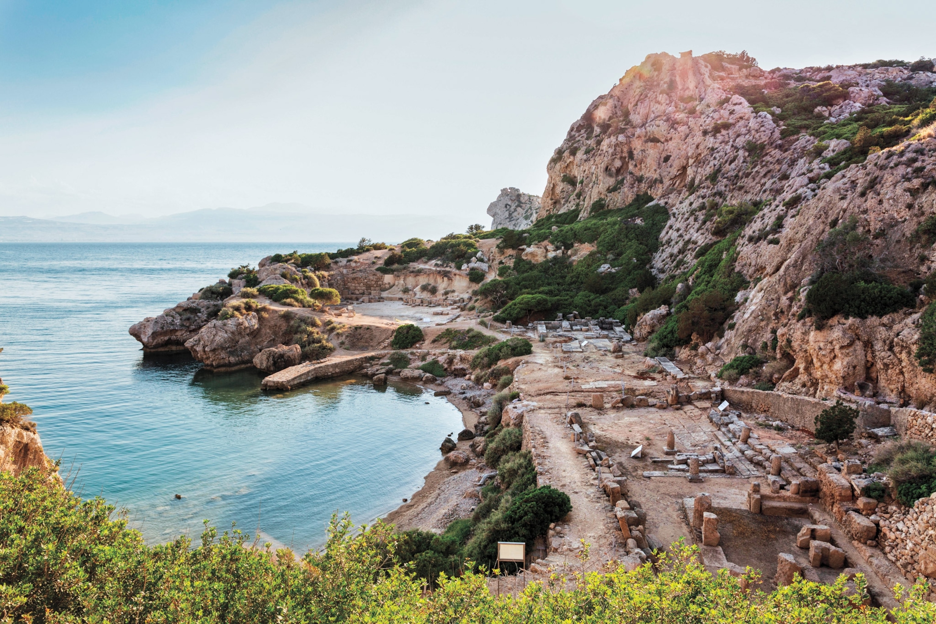 Photo of ancient city on side of cliff with water