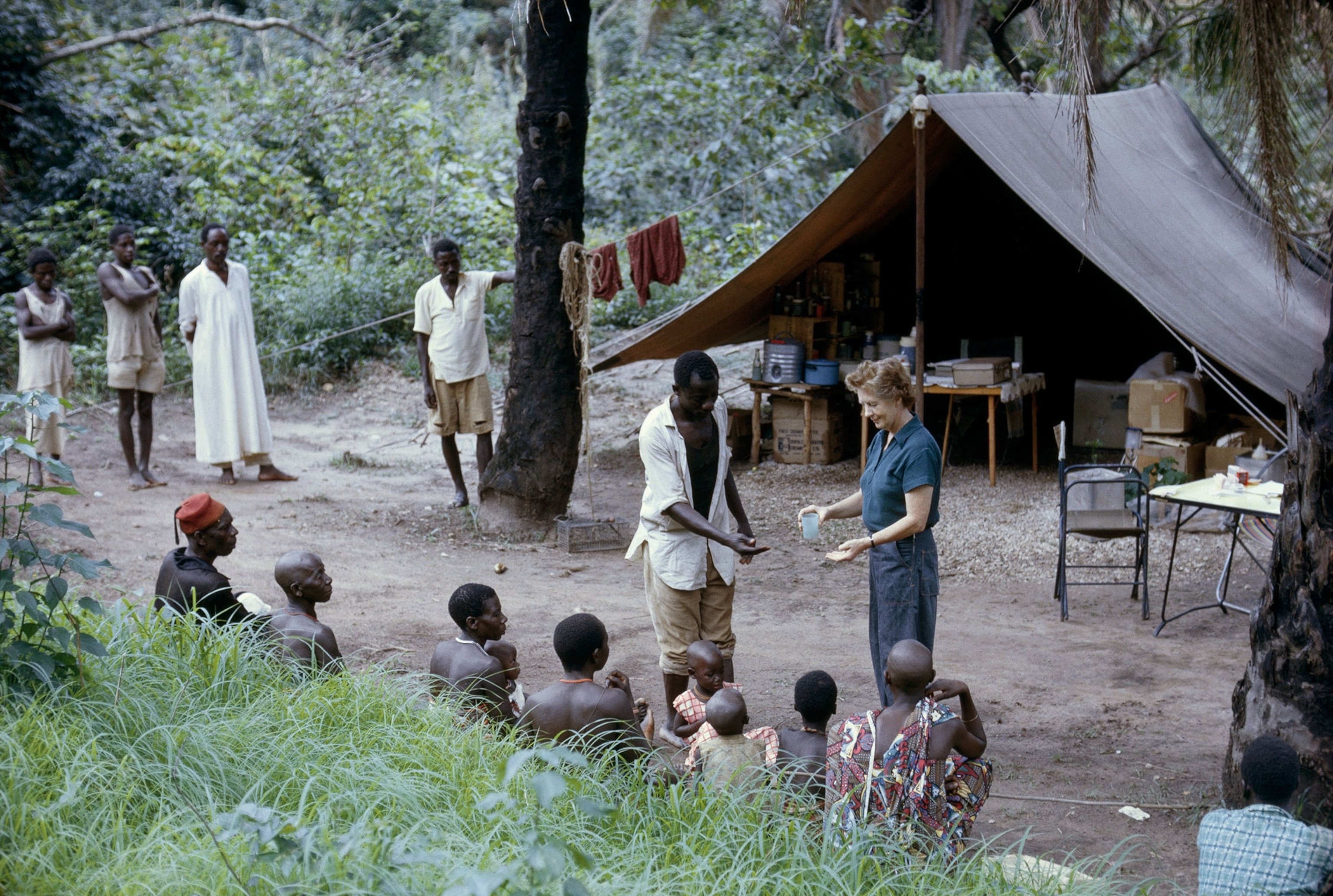 Vanne Morris-Goodall handing out medicine in a campsite
