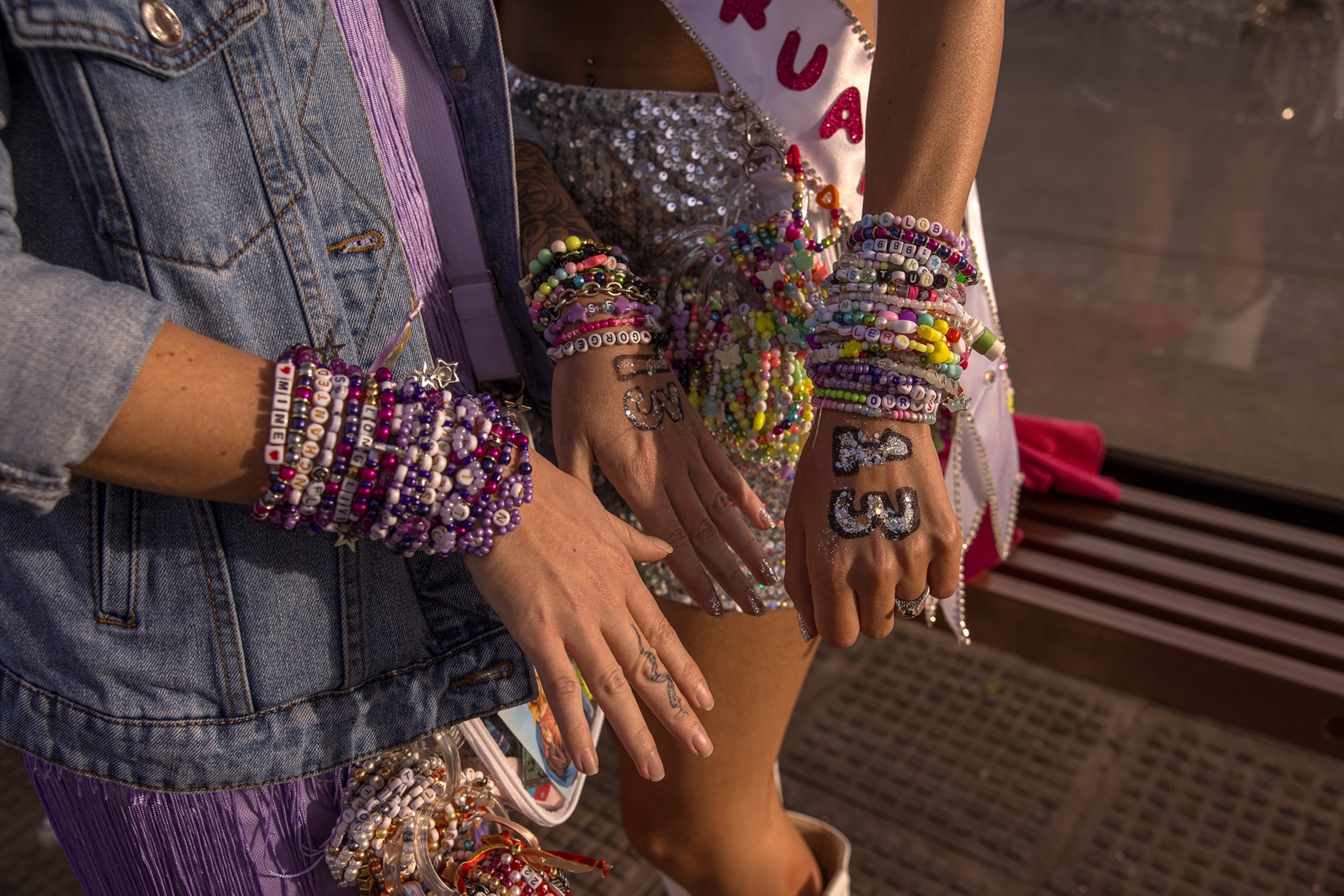 Sisters show off their friendship bracelets before Taylor Swift's Eras Tour at El Monumental Stadium in Buenos Aires, Argentina.