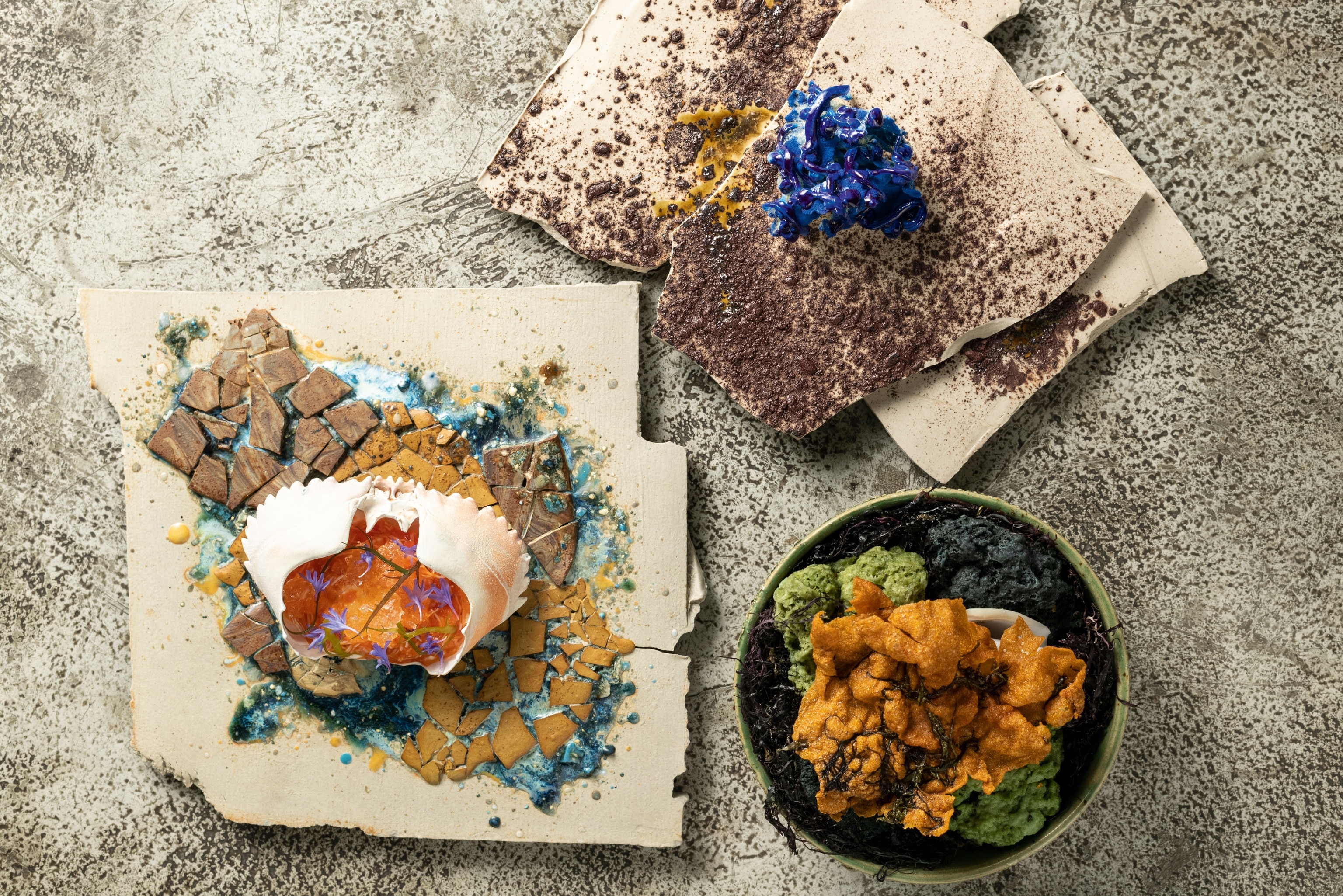 brightly coloured dishes shot overheal, featuring reds, greens, yellow and blues