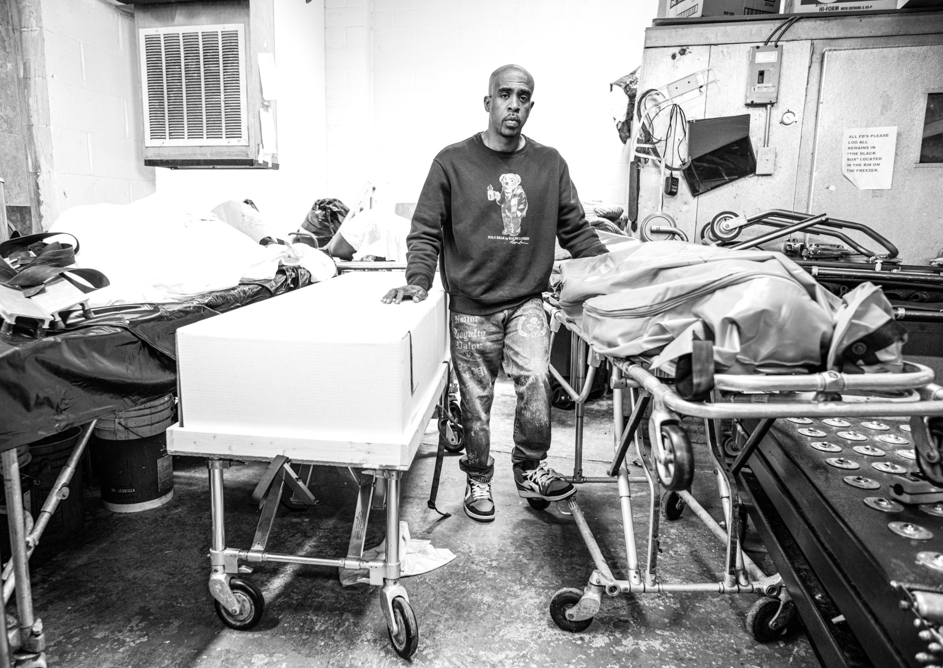 a person standing between two gurneys