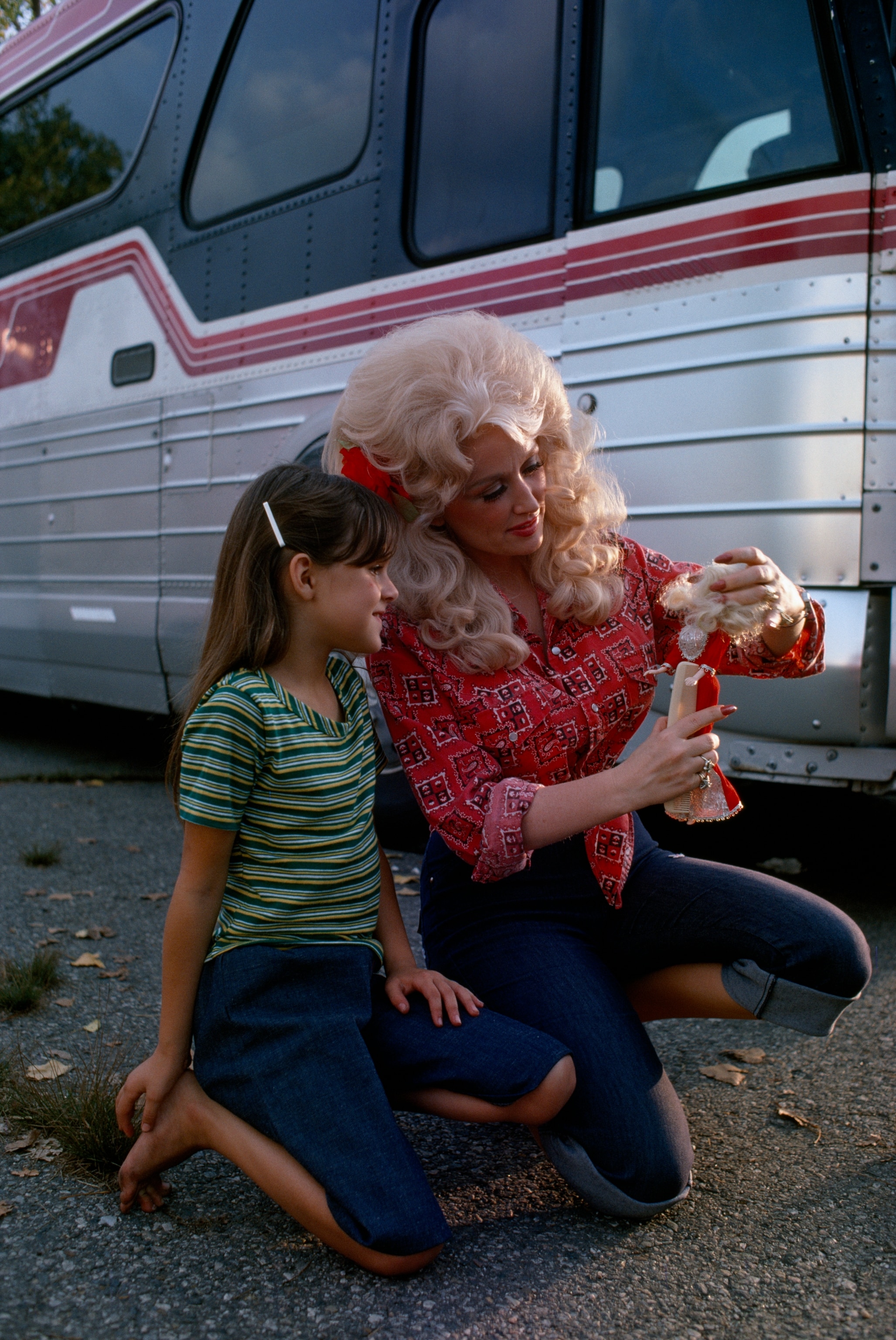 Country music star Dolly Parton meets a fan with a Dolly doll in September, 1977