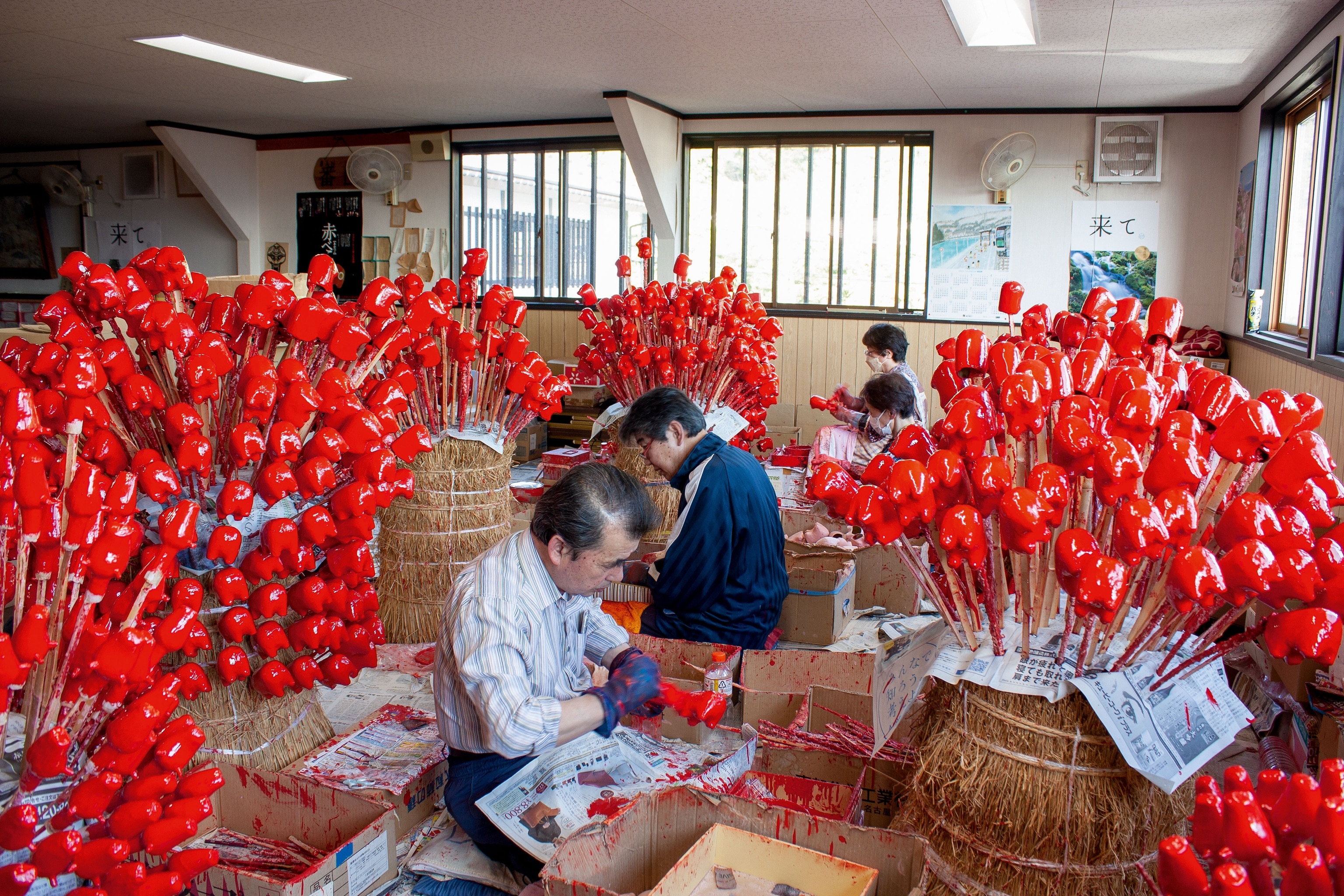 workers painting the casted paper-mache cows
