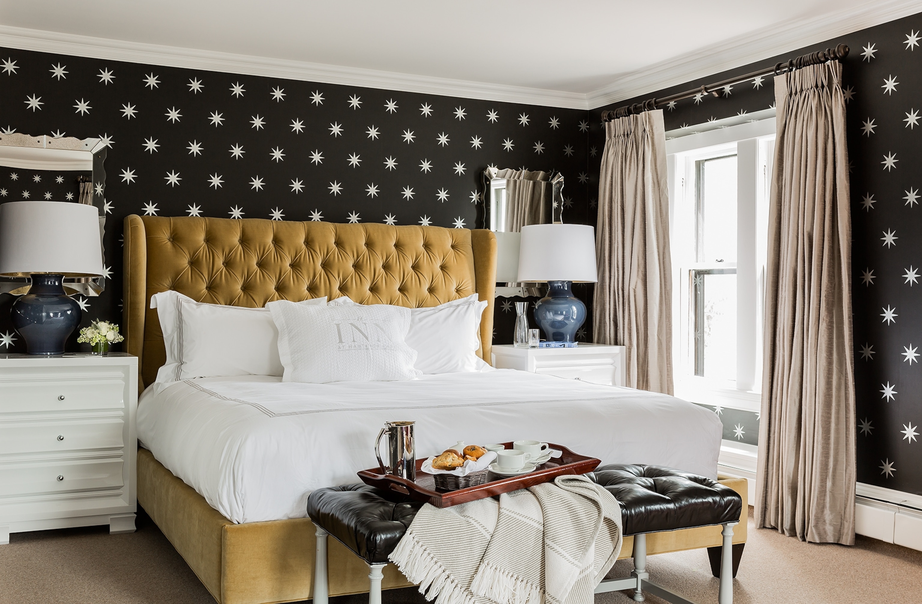 Located within the main house of The Inn at Hastings Park, this king suite is one of 22 guest rooms. Its dramatic wallpaper showcases a star pattern, a significant, powerful and popular symbol during the American Revolution.