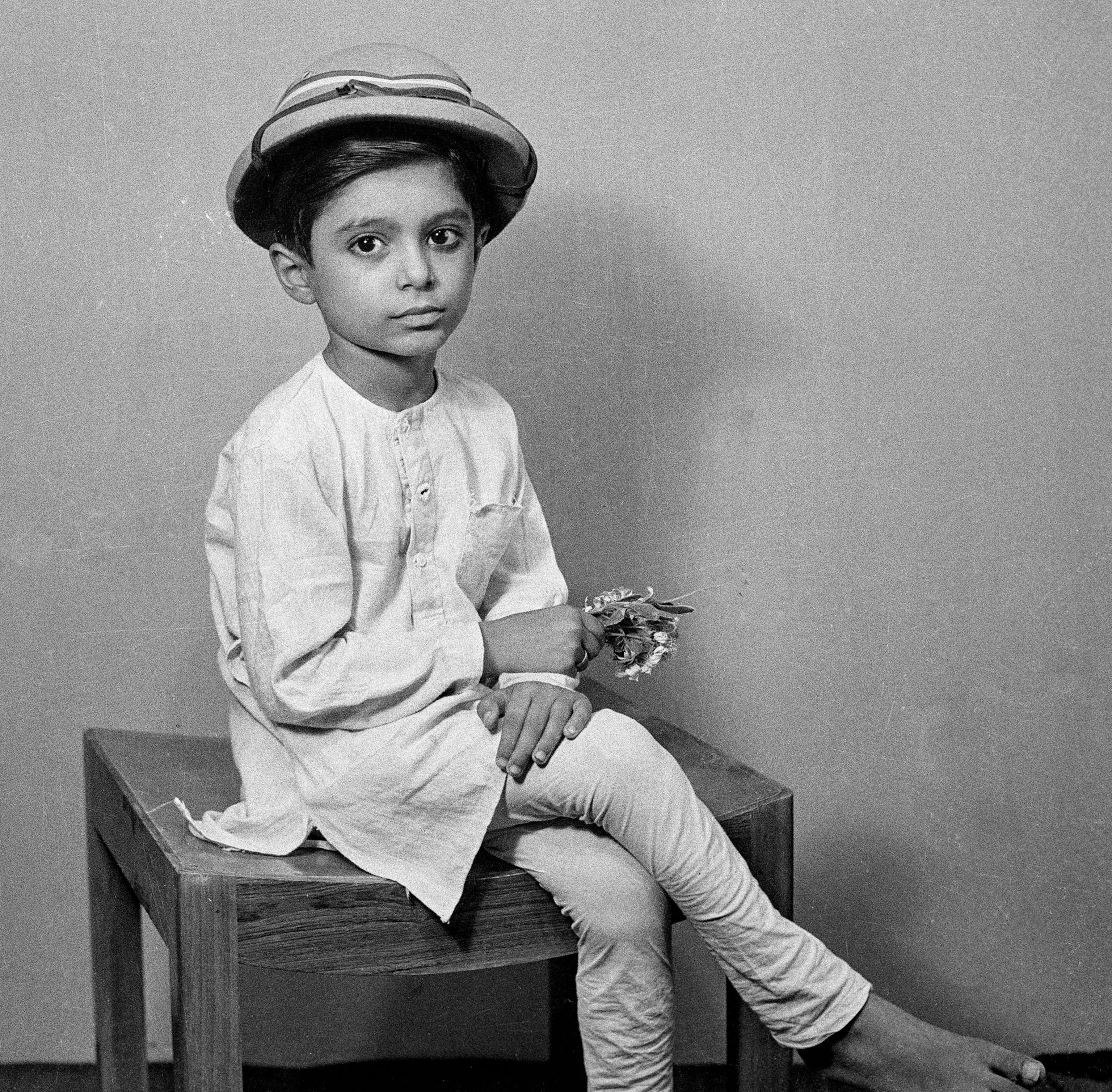 Boy wearing the kurta pajama, in a studio photo taken in India, circa 1940