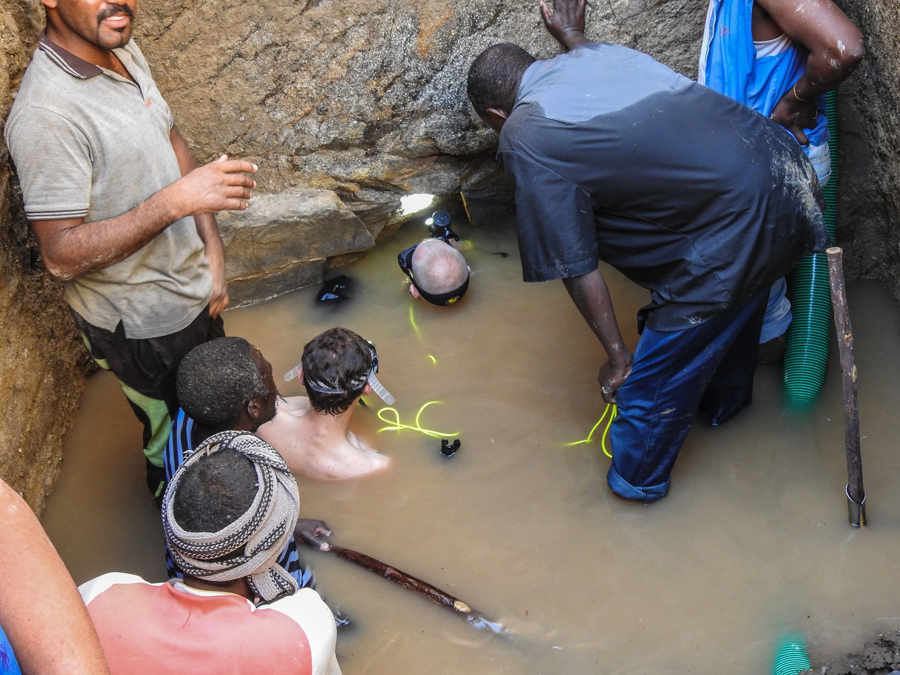 people preparing to dive underneath a pyramid in Sudan