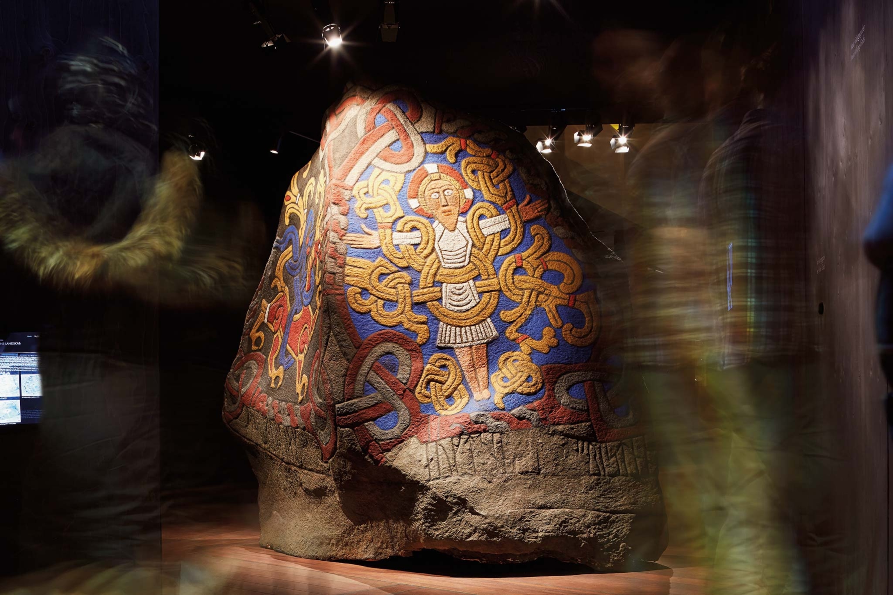 Vibrant hues adorn a depiction of Christ on a replica of a Jelling Stone, appearing as they would have when Bluetooth first erected it.