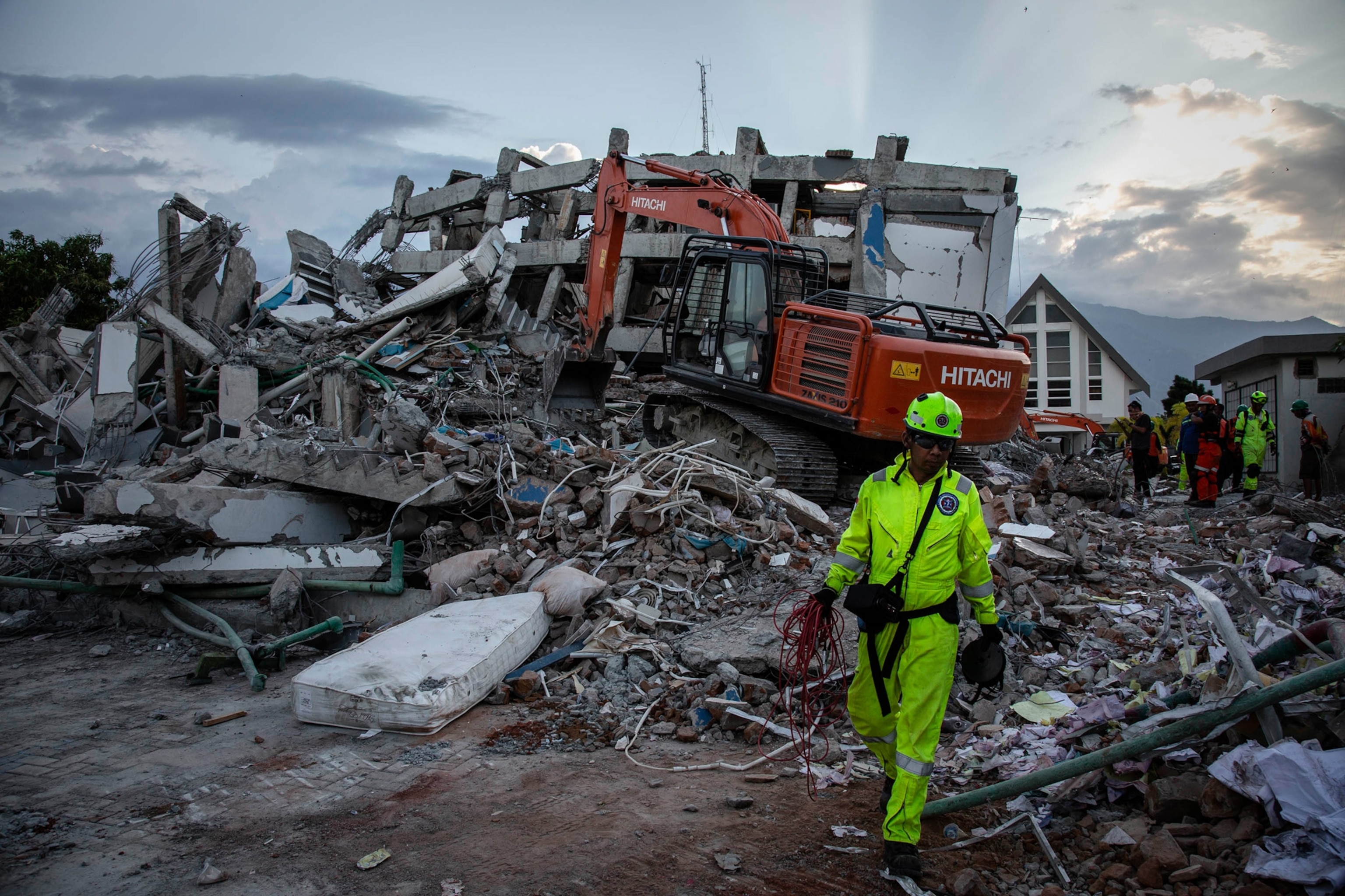 a search team at the site where a hotel collapsed after an earthquake hit Palu