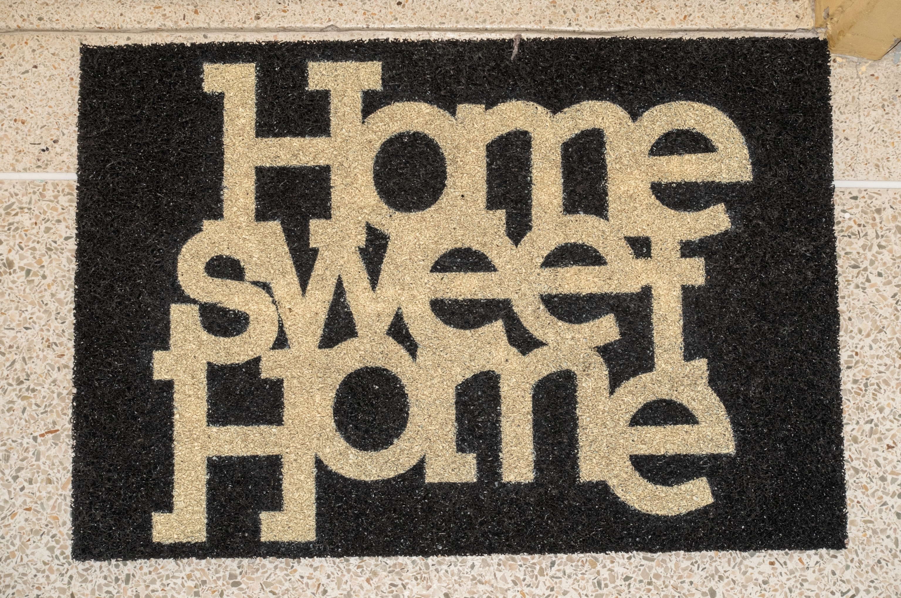 a home entrance mat that says "home sweet home"