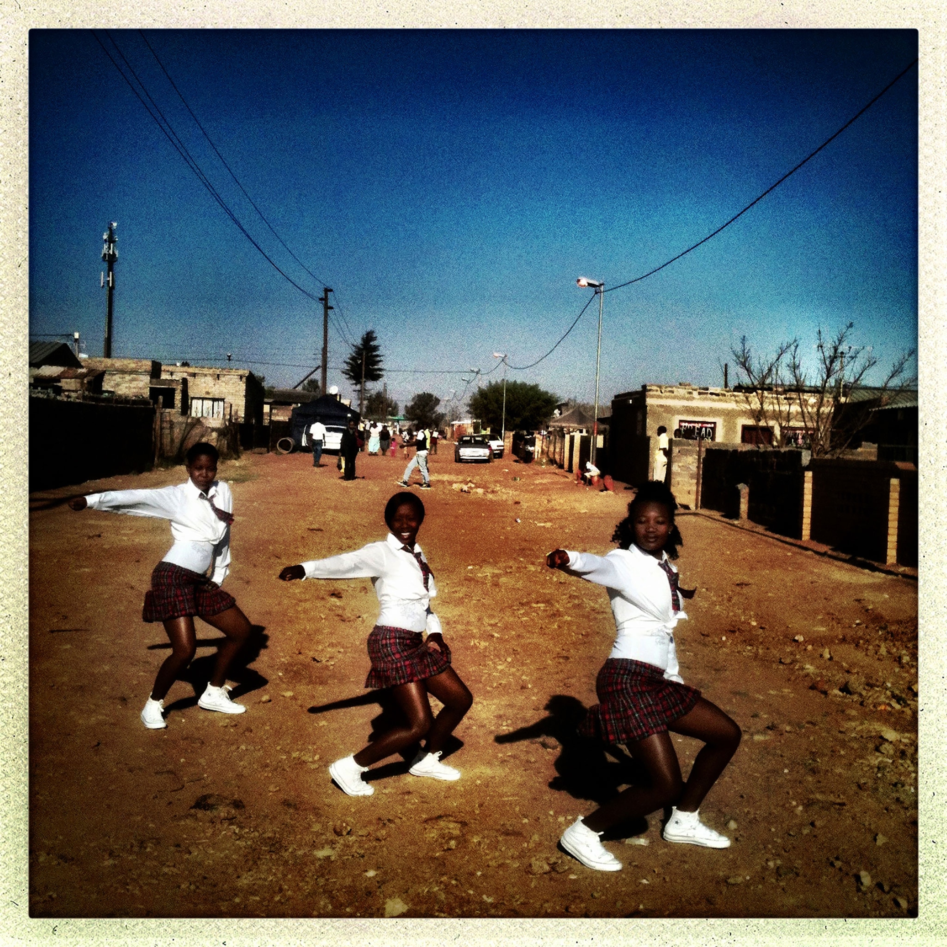 The Real Action Ladies practice in the road in Orange Farm Township, South Africa