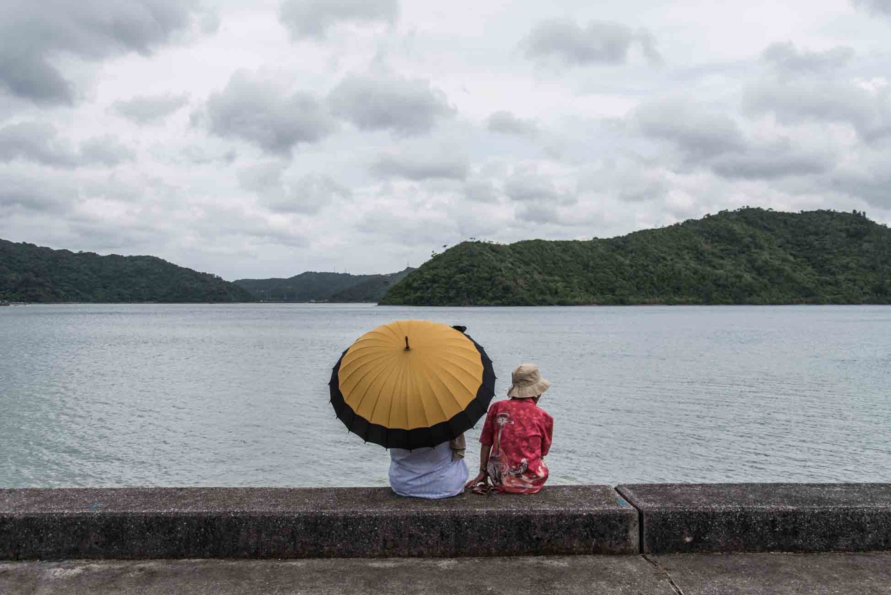 two elderly people in front of Shioya Bay, near the "village of longevity", Ogimi, Japan