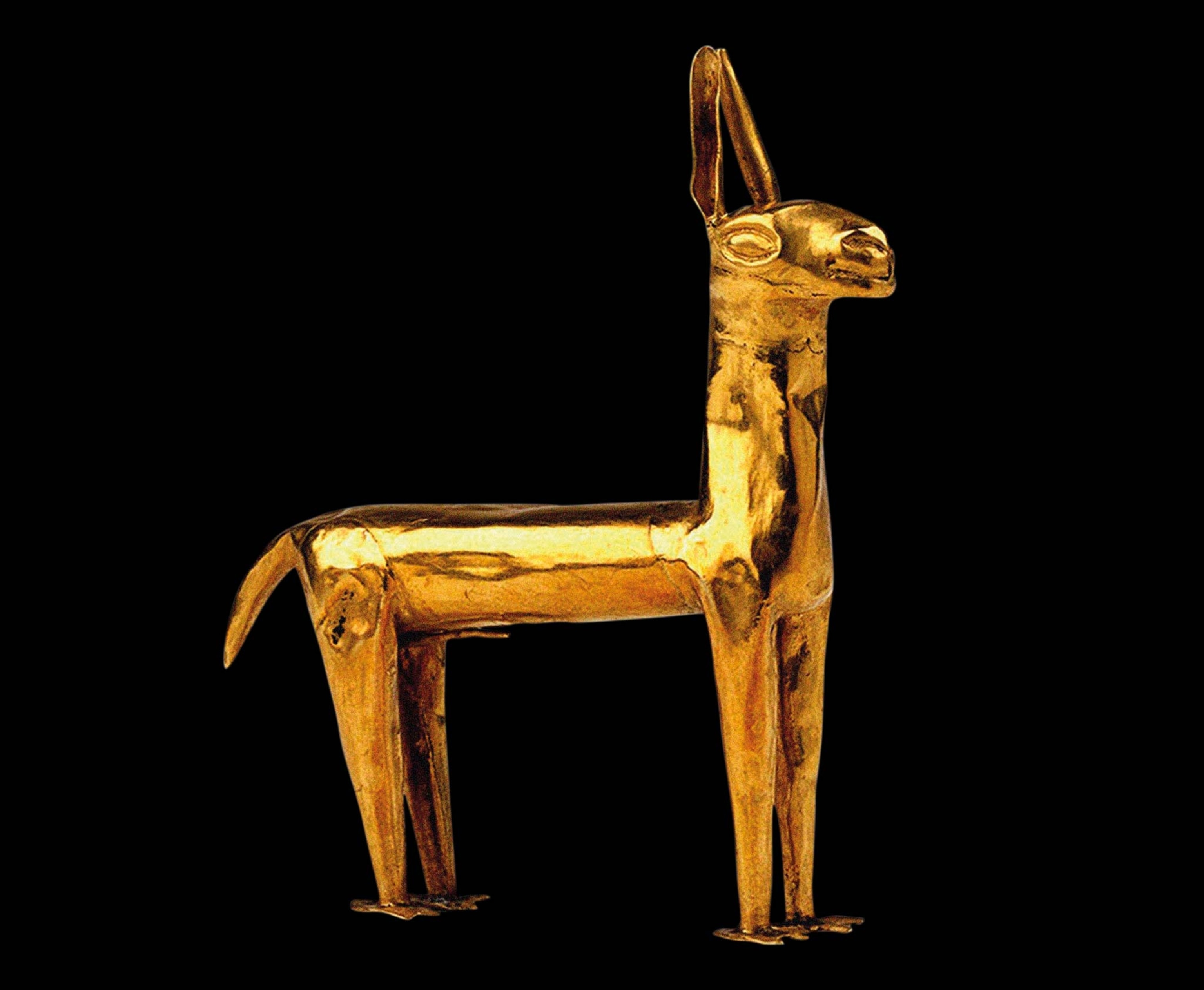 A small golden llama measures just over two inches high and is made from three fine sheets of gold that have been beaten smooth.