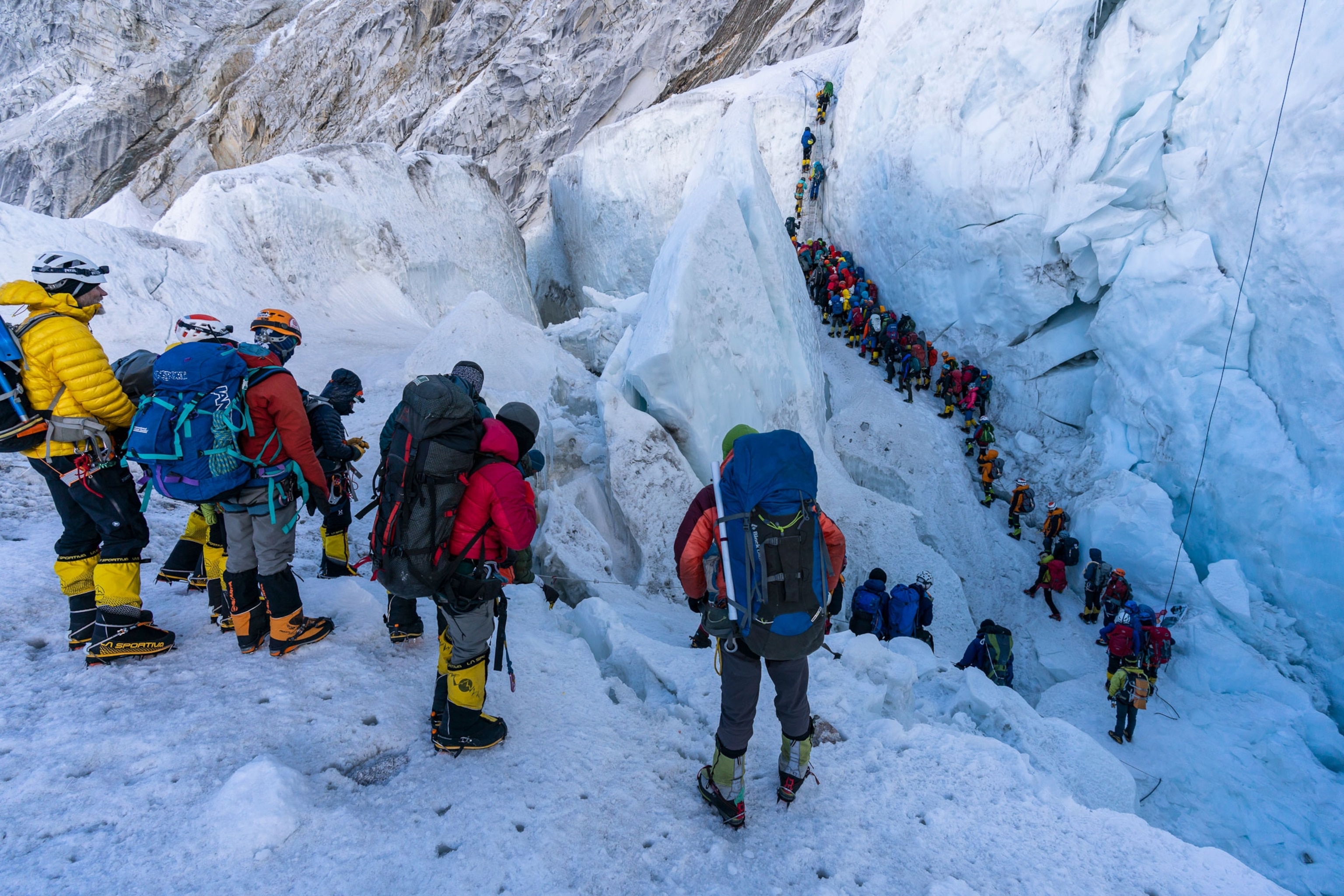 a line of climbers working their way through the Khumbu ice fall on Mount Everest
