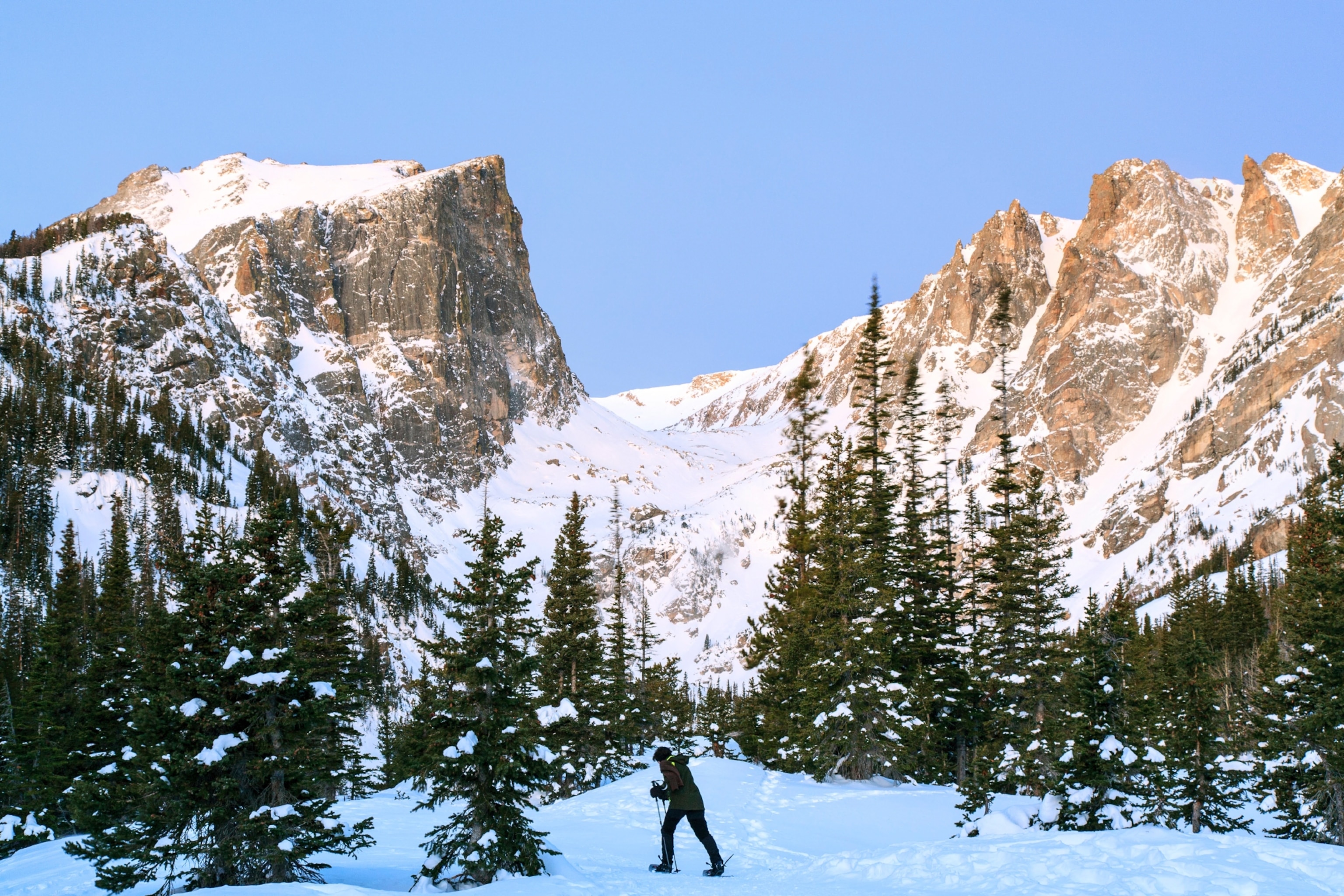 A person snowshoes across