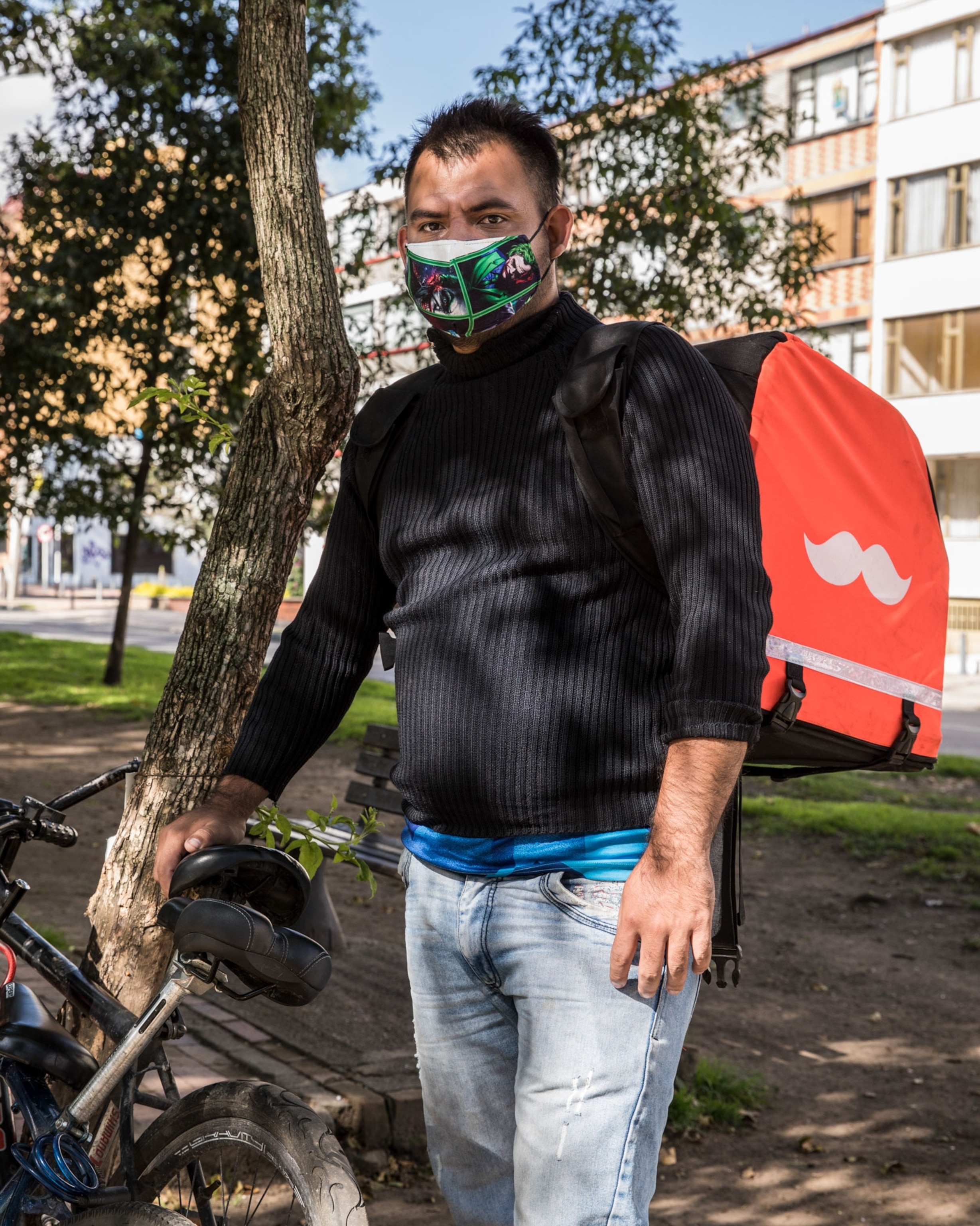 a man working to deliver food in Bogota