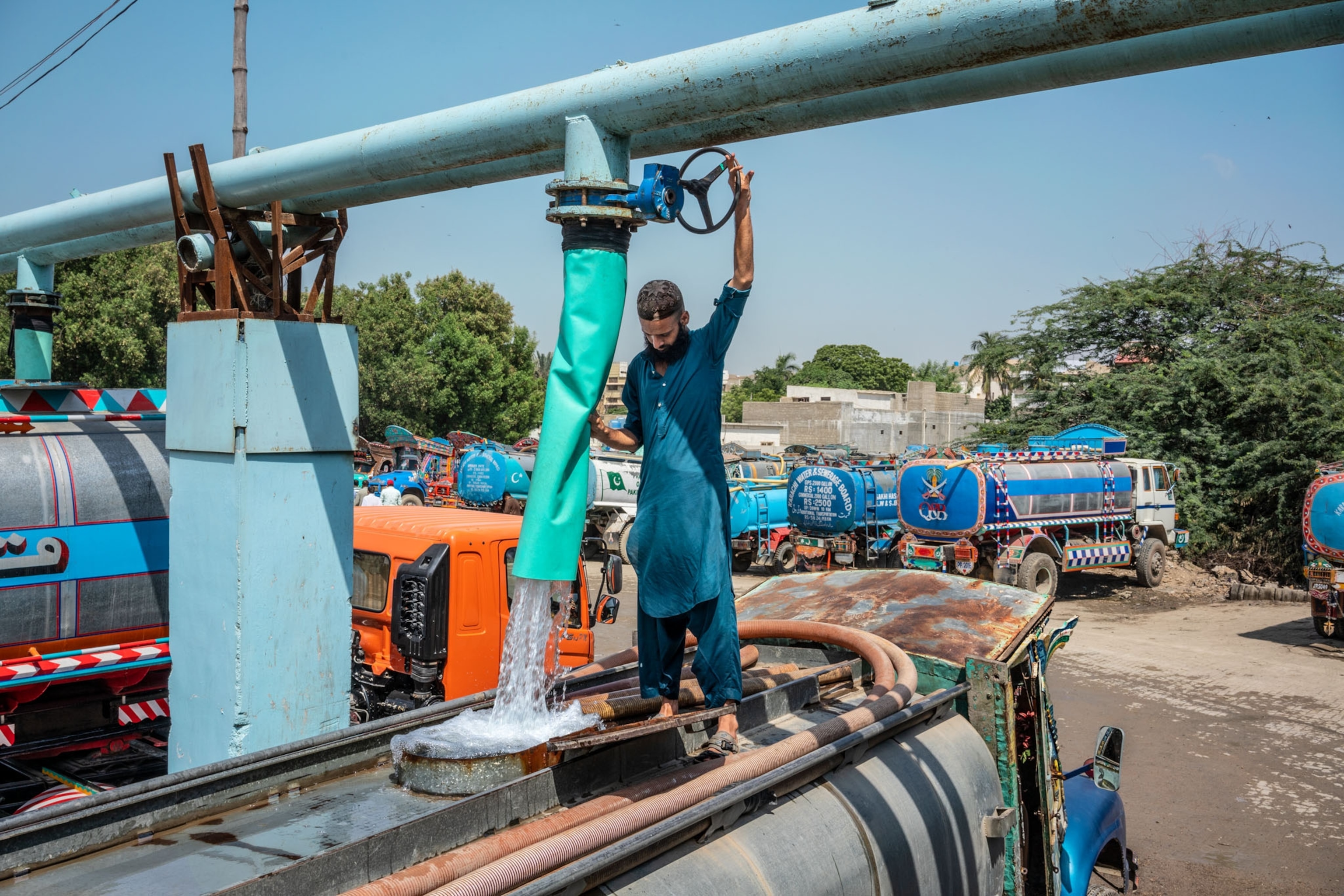 a man using a large water pump machine