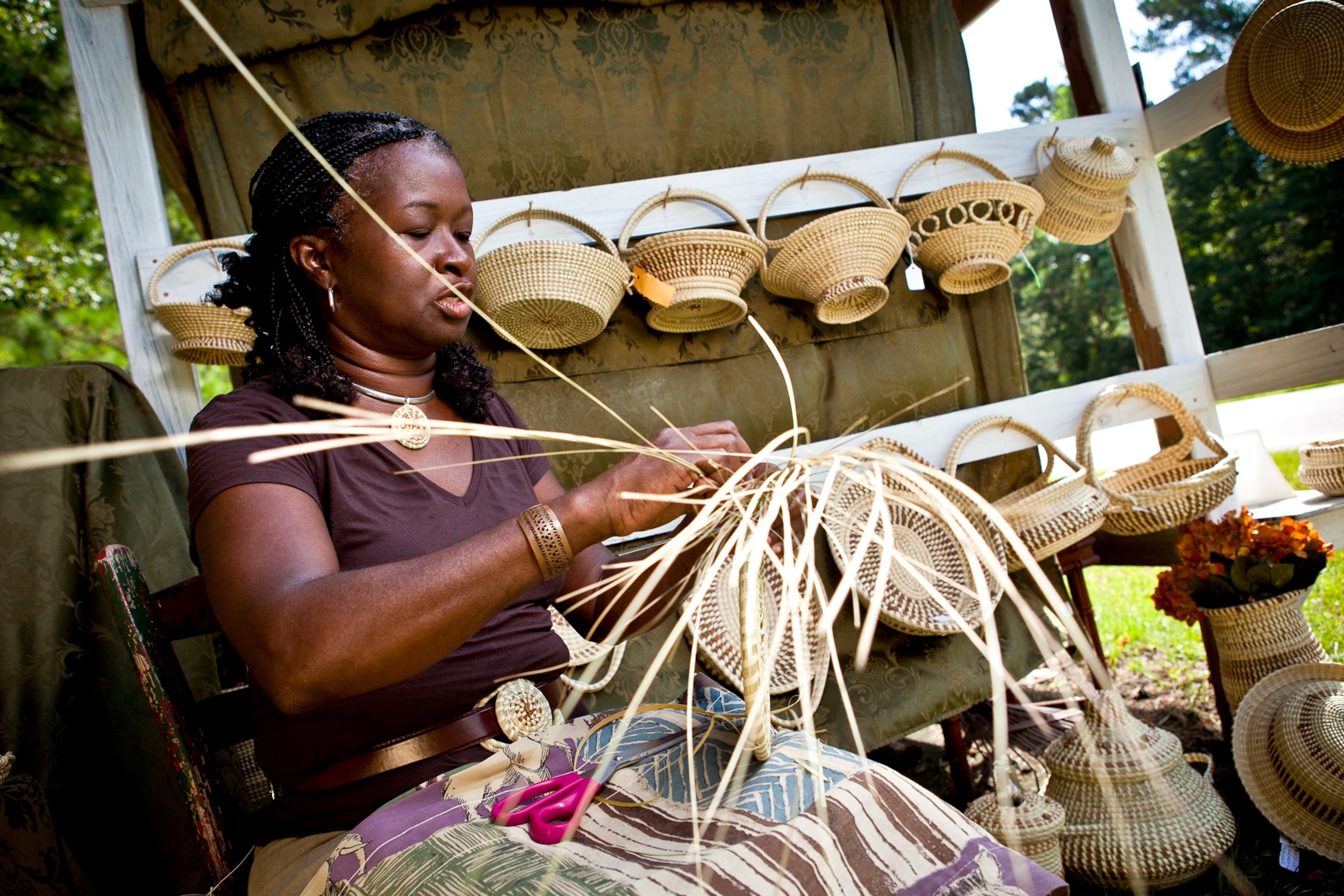 a Gullah sweet grass basket weaver at her stand in Mt Pleasant, South Carolina