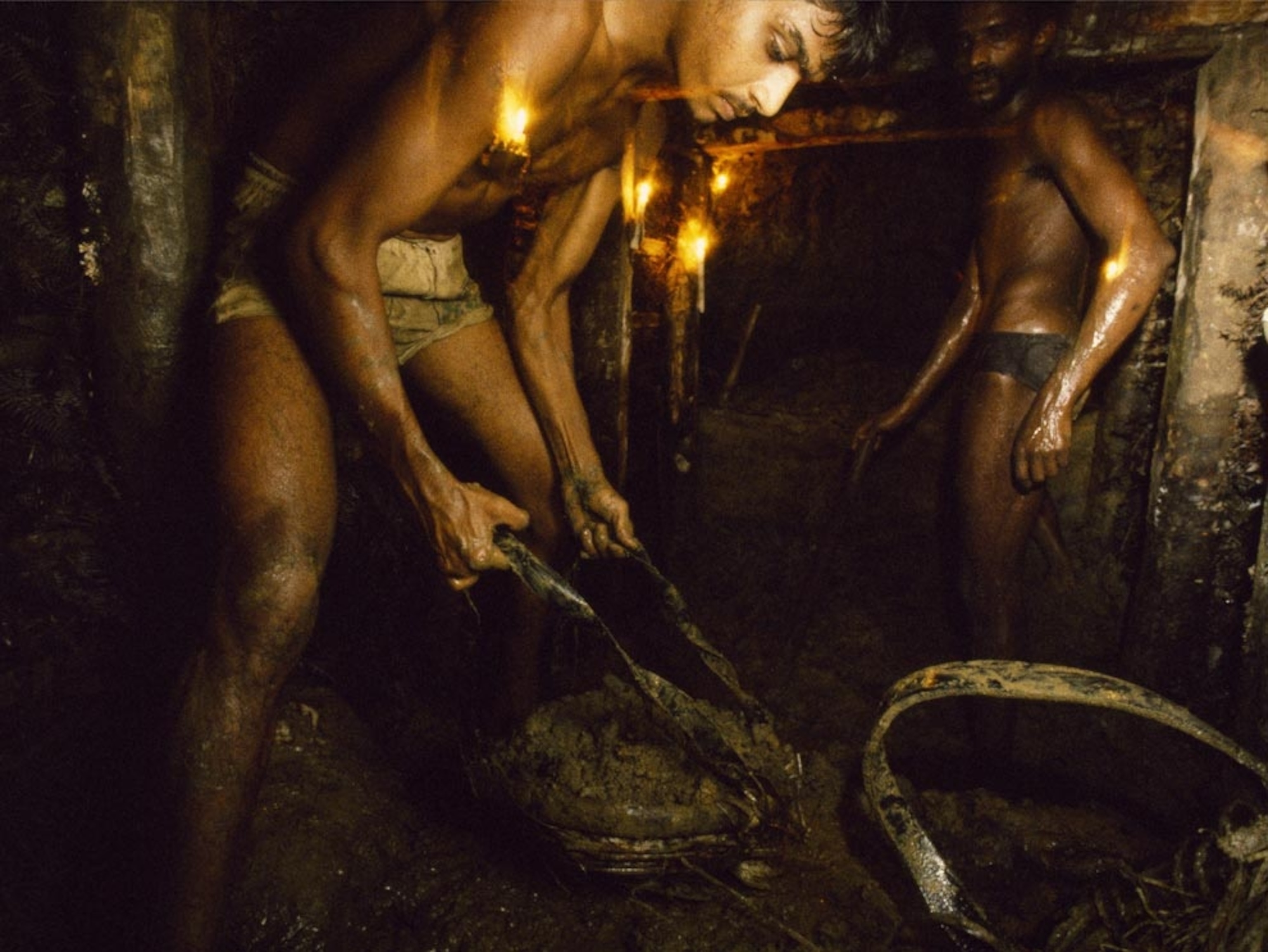 Gem miners working by candlelight