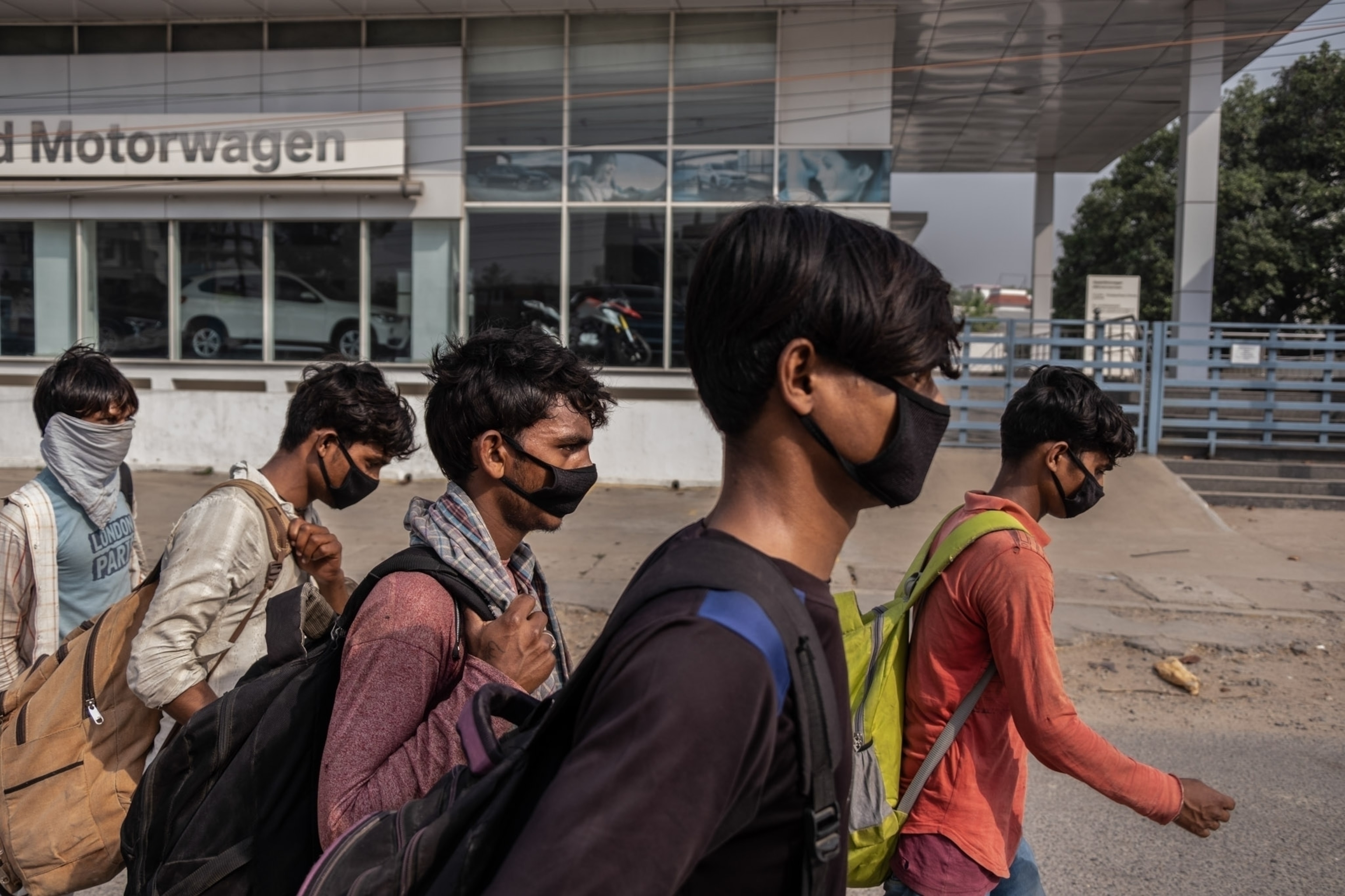 a few people walking wearing masks