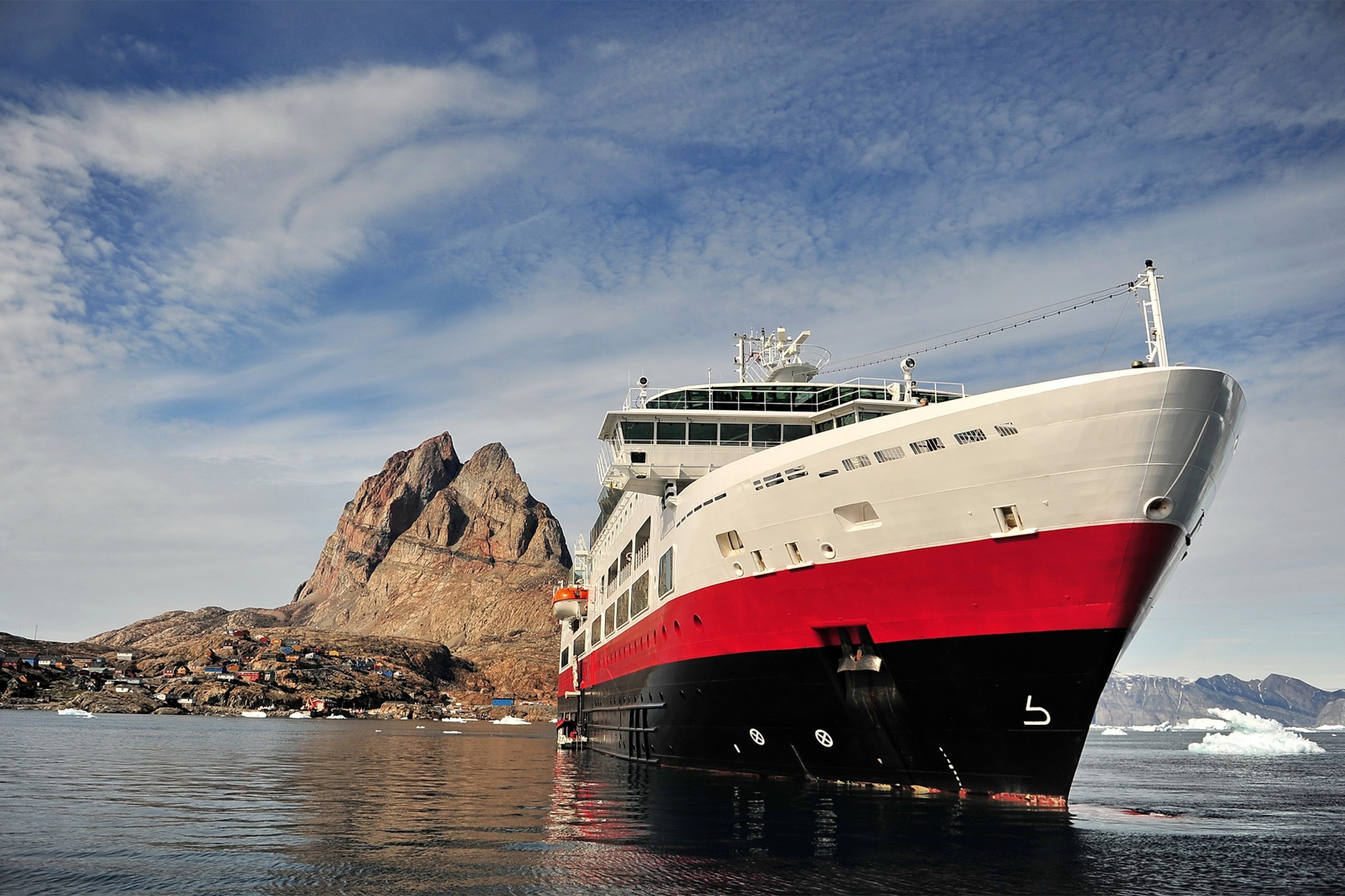 Greenland. Icebergs, mountains and the sea.