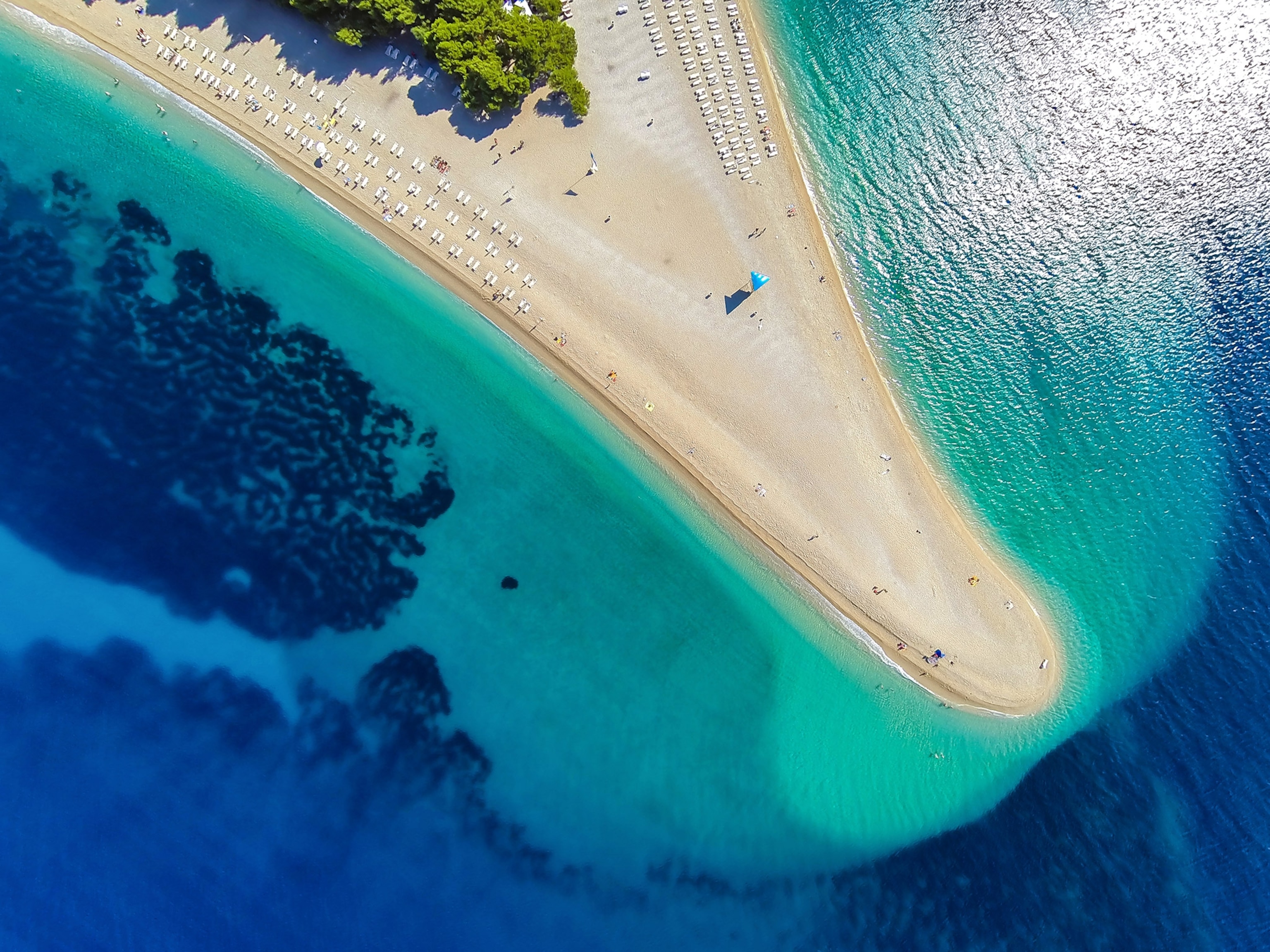 an aerial view of Zlatni Rat beach in Bol in Brac, Croatia