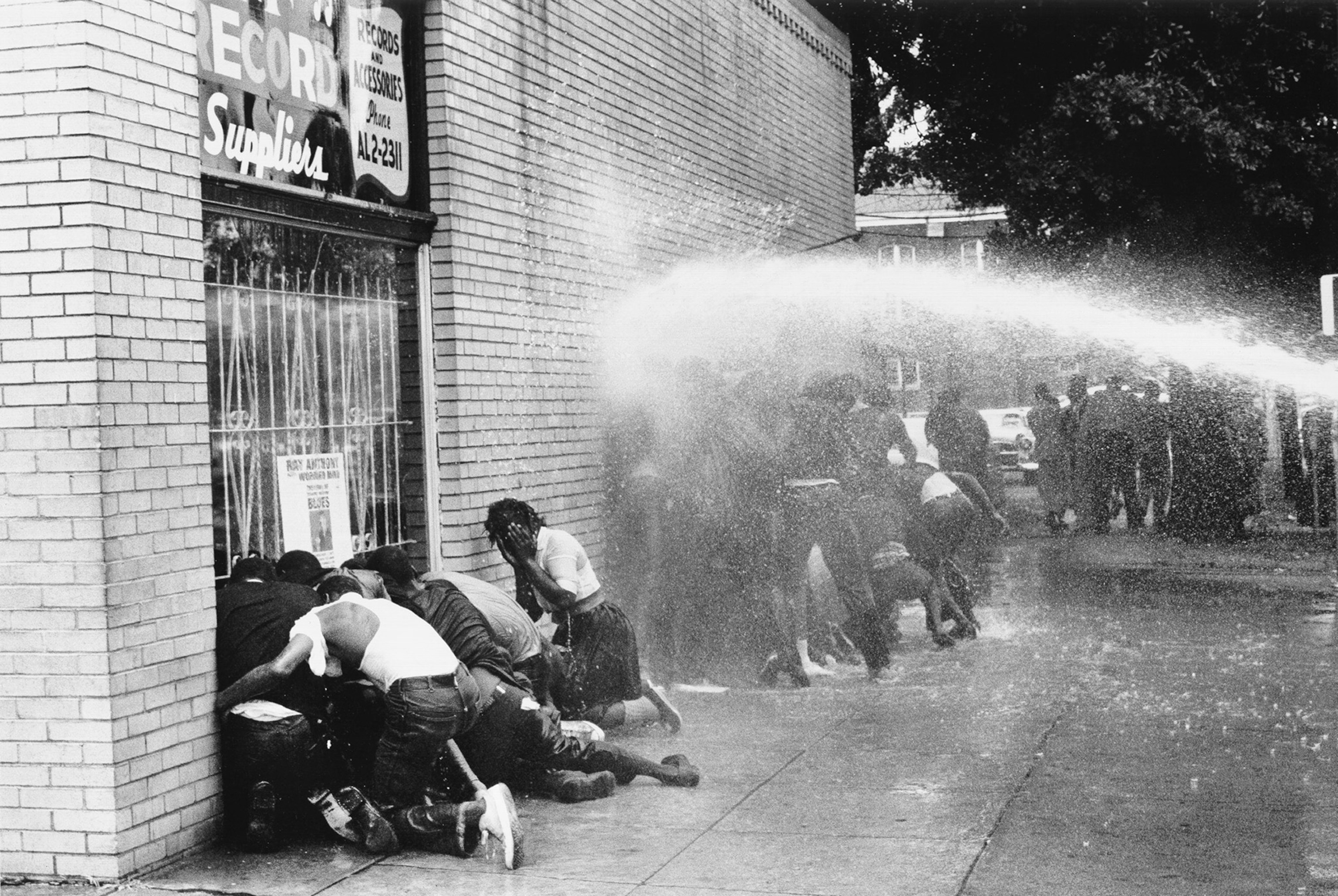 a water cannon being used on young, black protesters