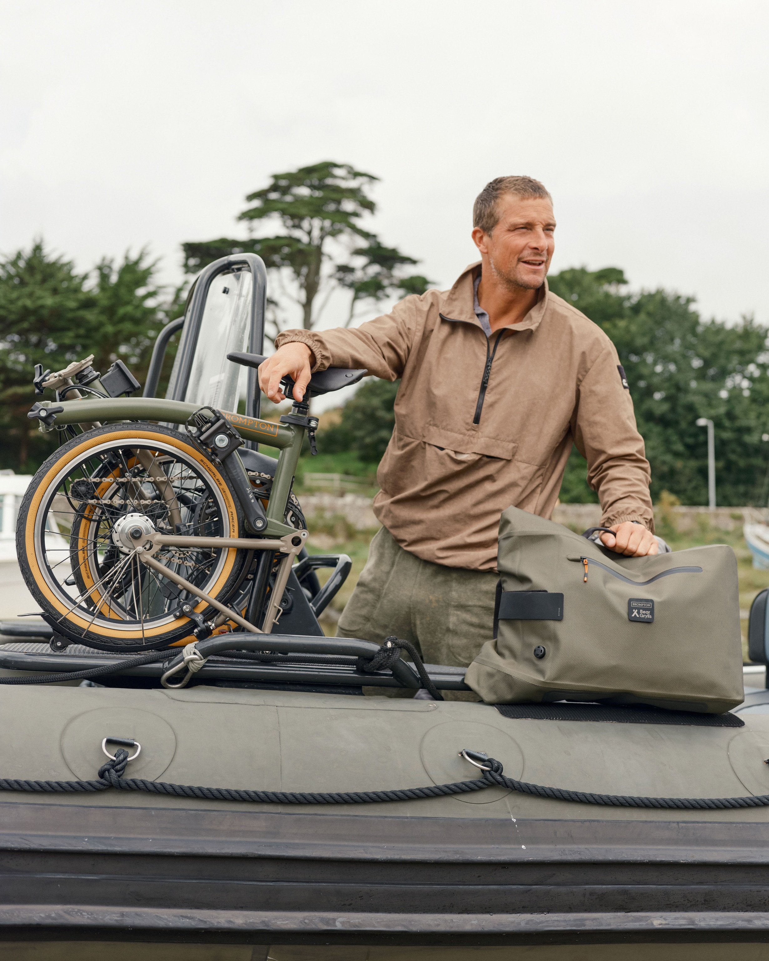 man standing with packed bike in inflated boat