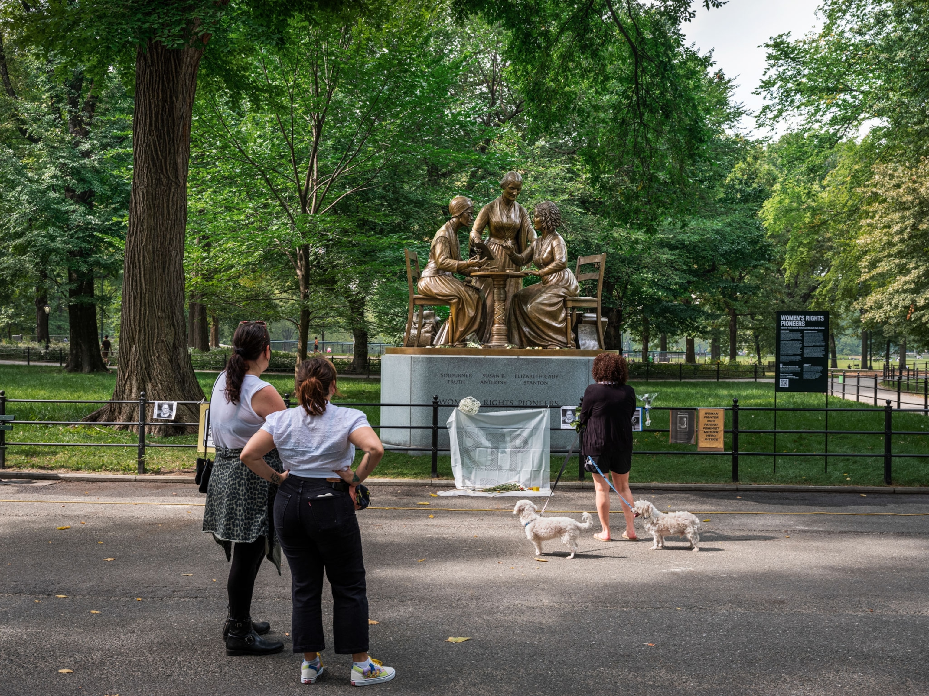 women looking at the Women’s Rights Pioneers Monument in Central Park, New York City