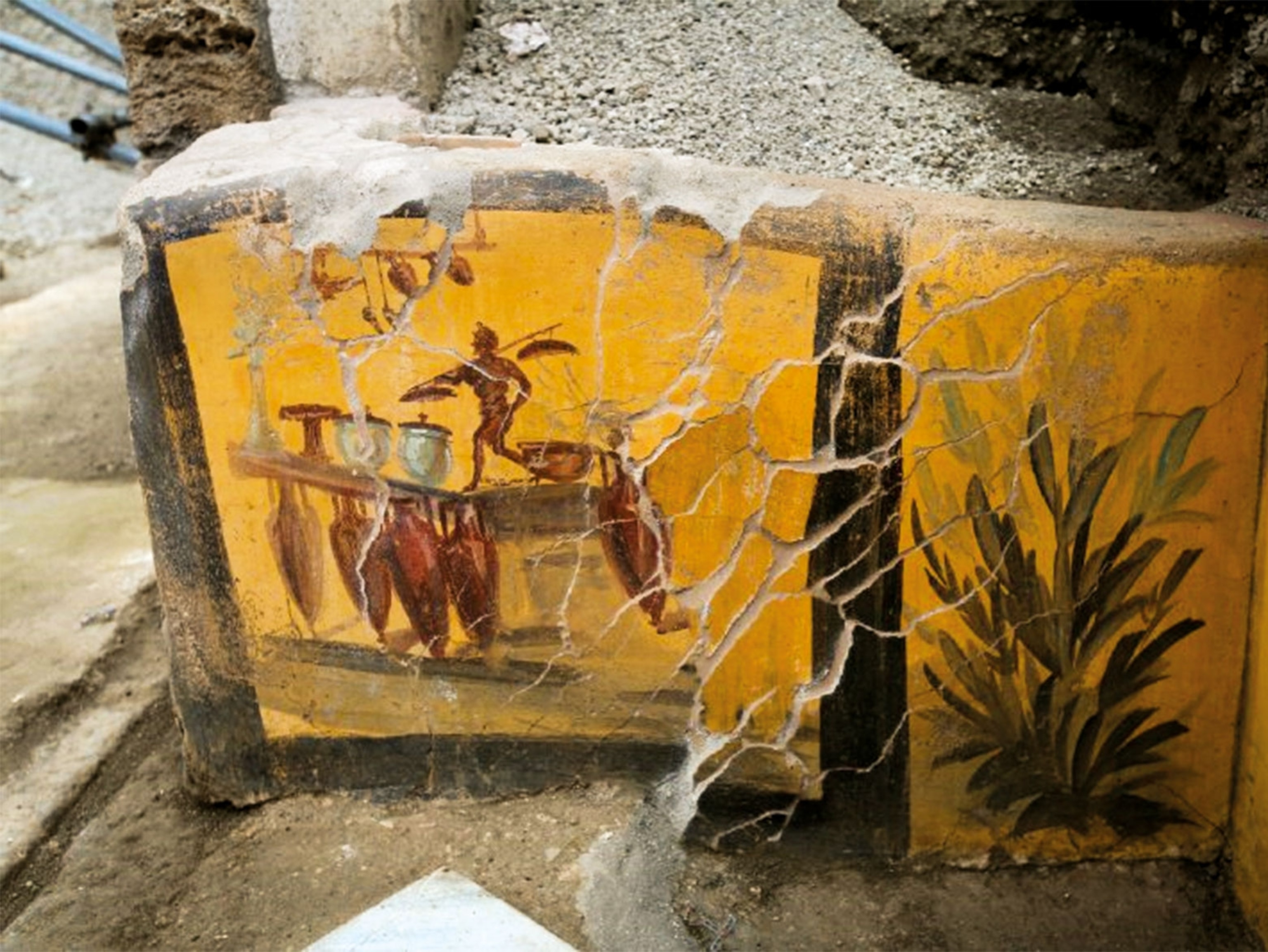 a fresco of a man at a cart with pots and cooking equipment