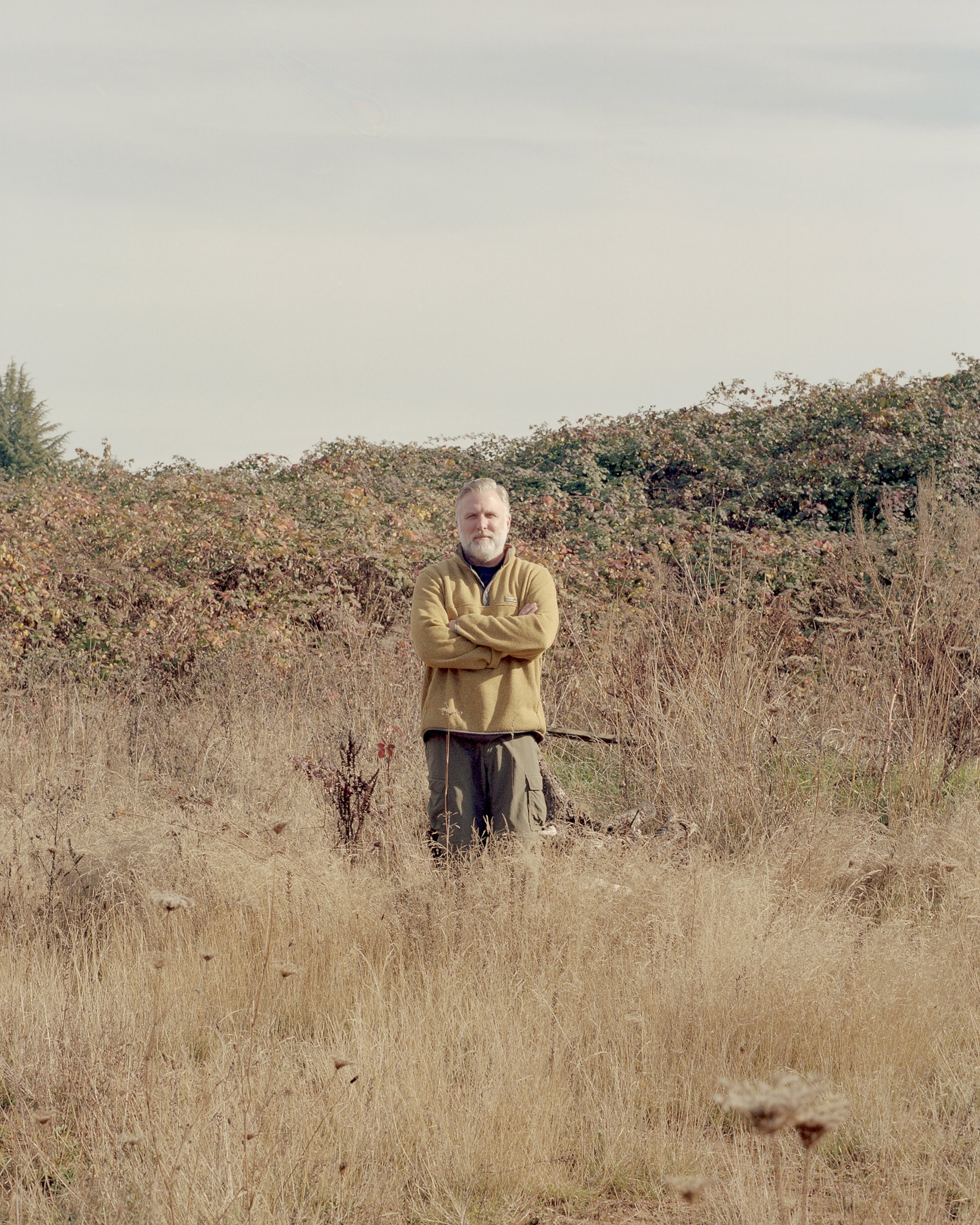 Cliff Barackman is a co-owner of the North American Bigfoot Center stands for a portrait in a field