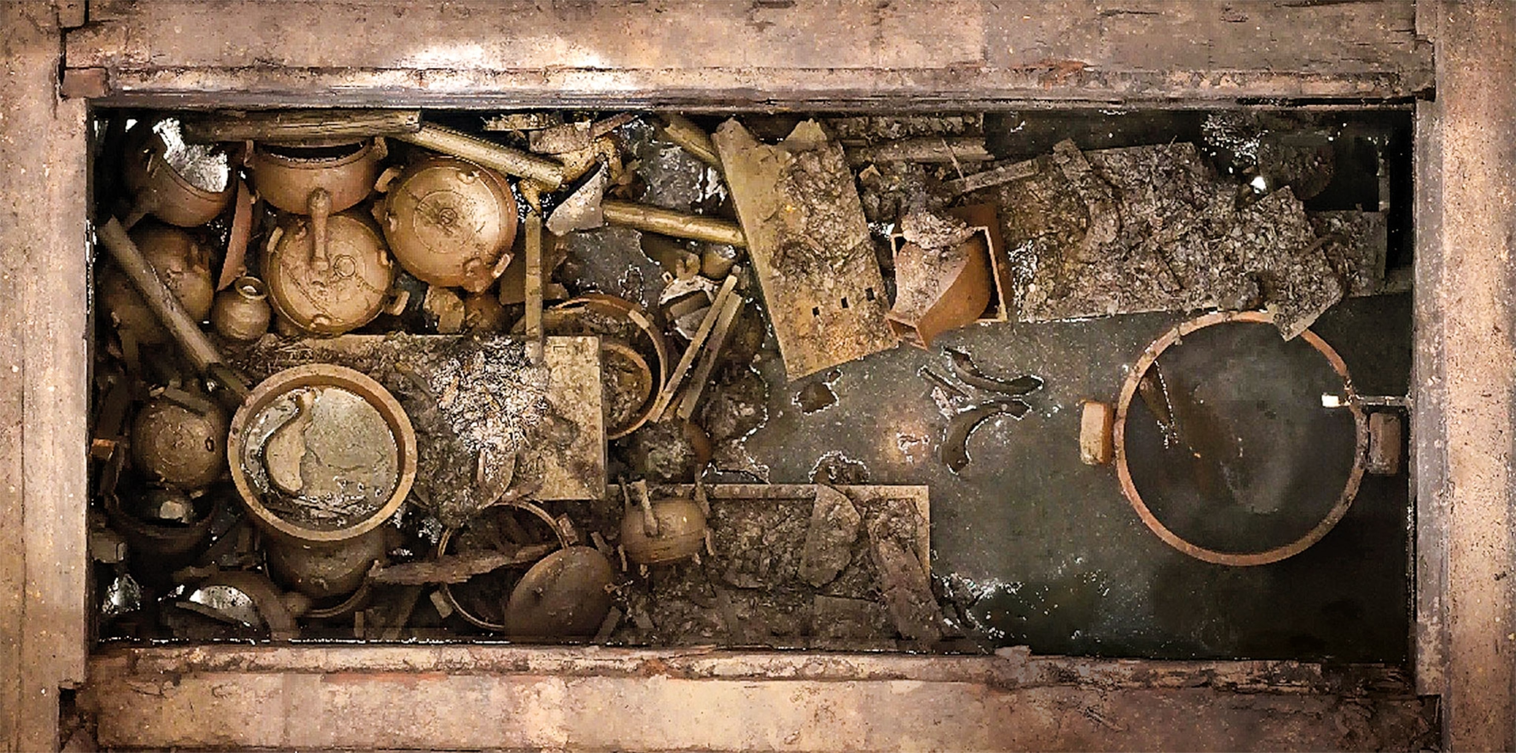 A top-down view of various artifacts scattered among an excavation site