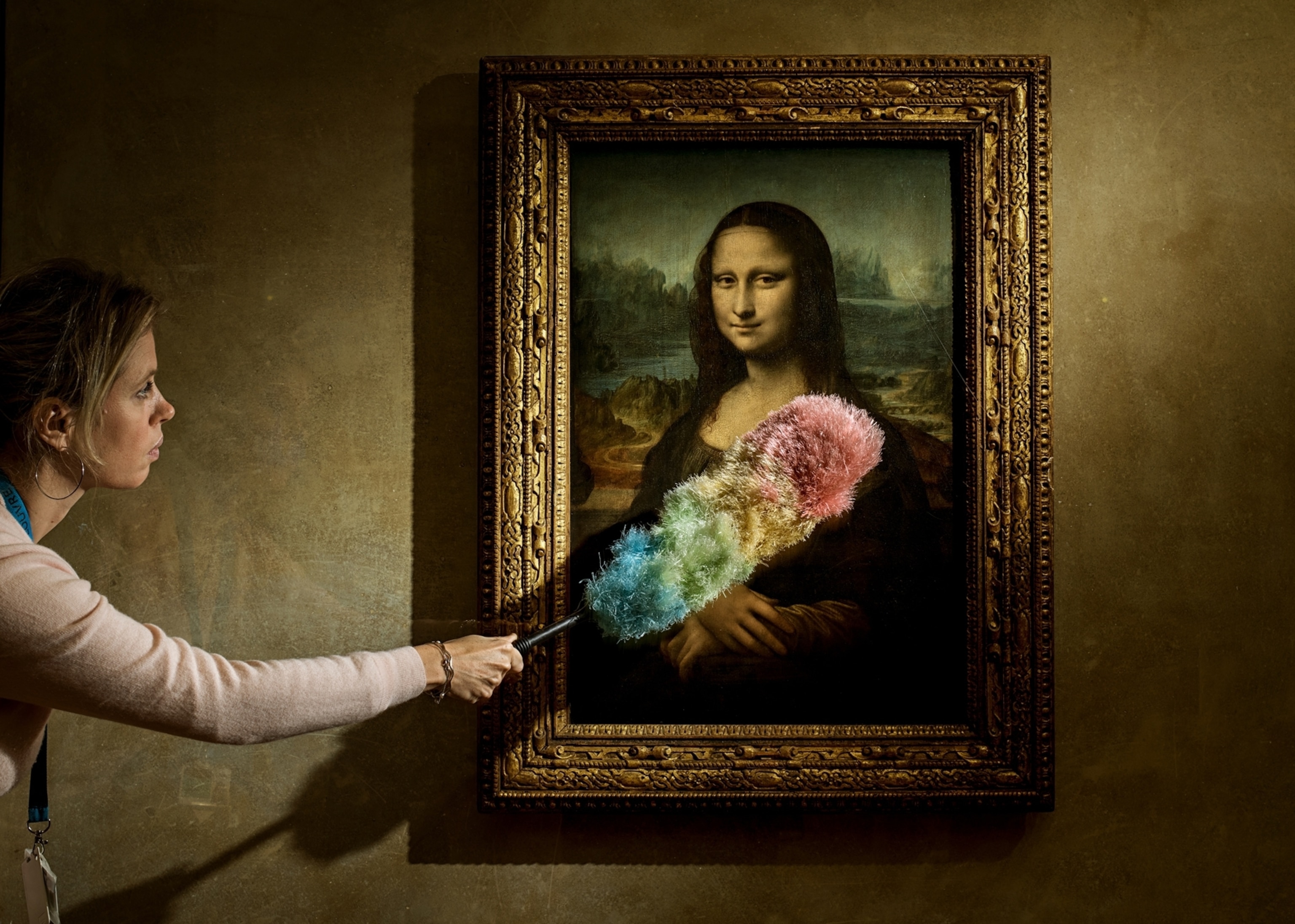 a woman cleaning the Mona Lisa with a rainbow duster in mood lighting