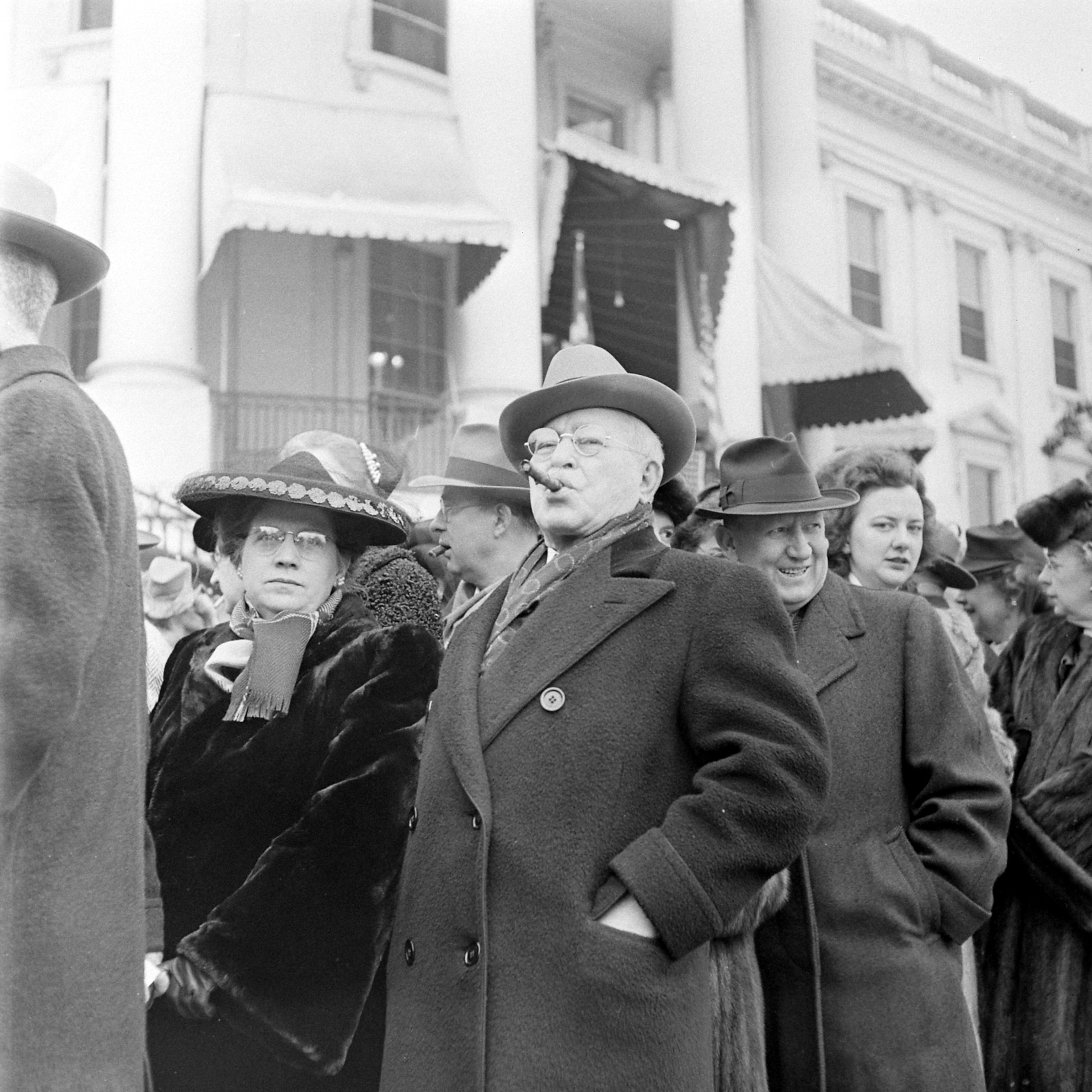 a man smoking a cigar in a crowd of people