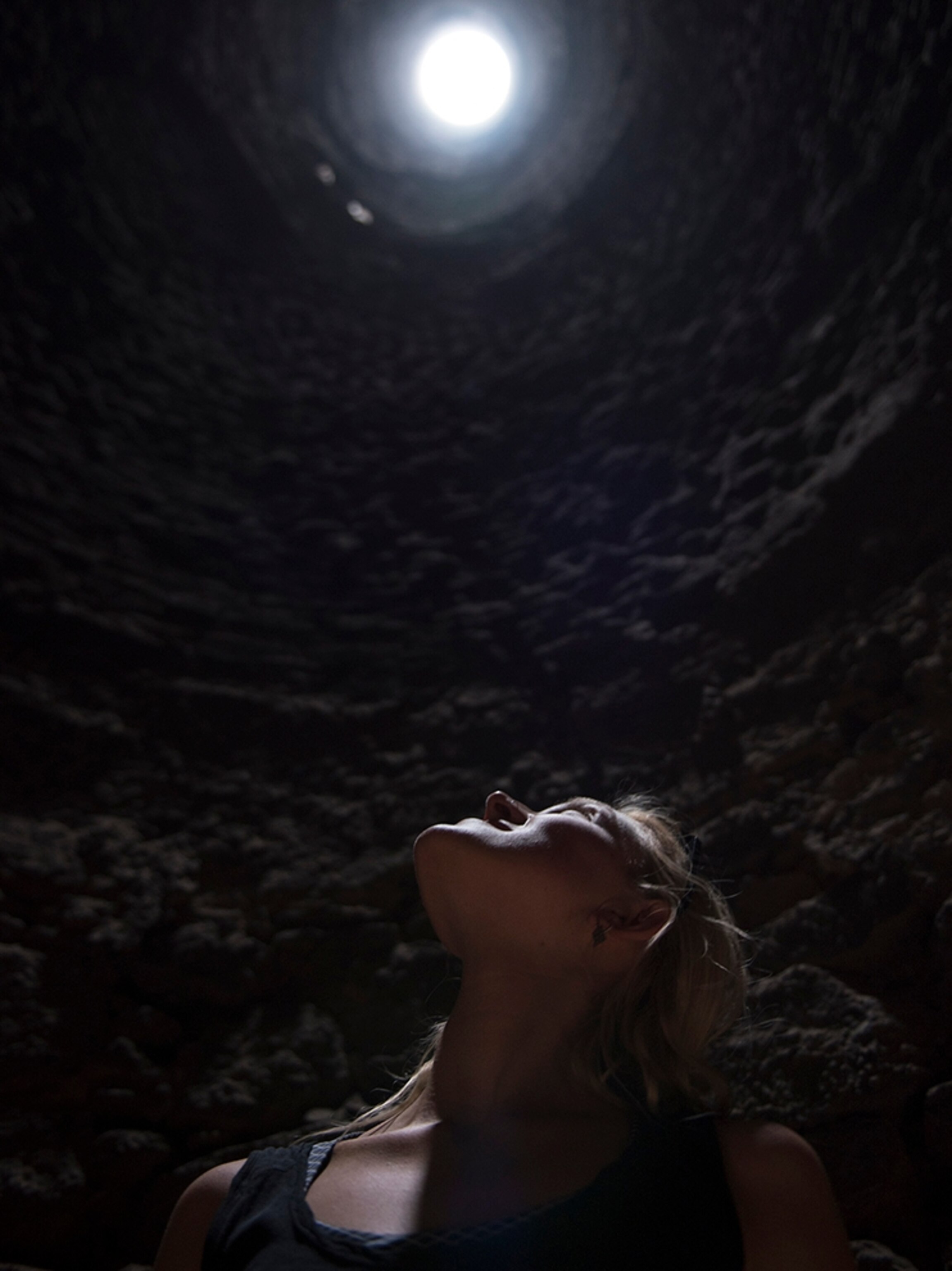 a woman looking up through a smelting tower of silver mine in Baja, Mexico