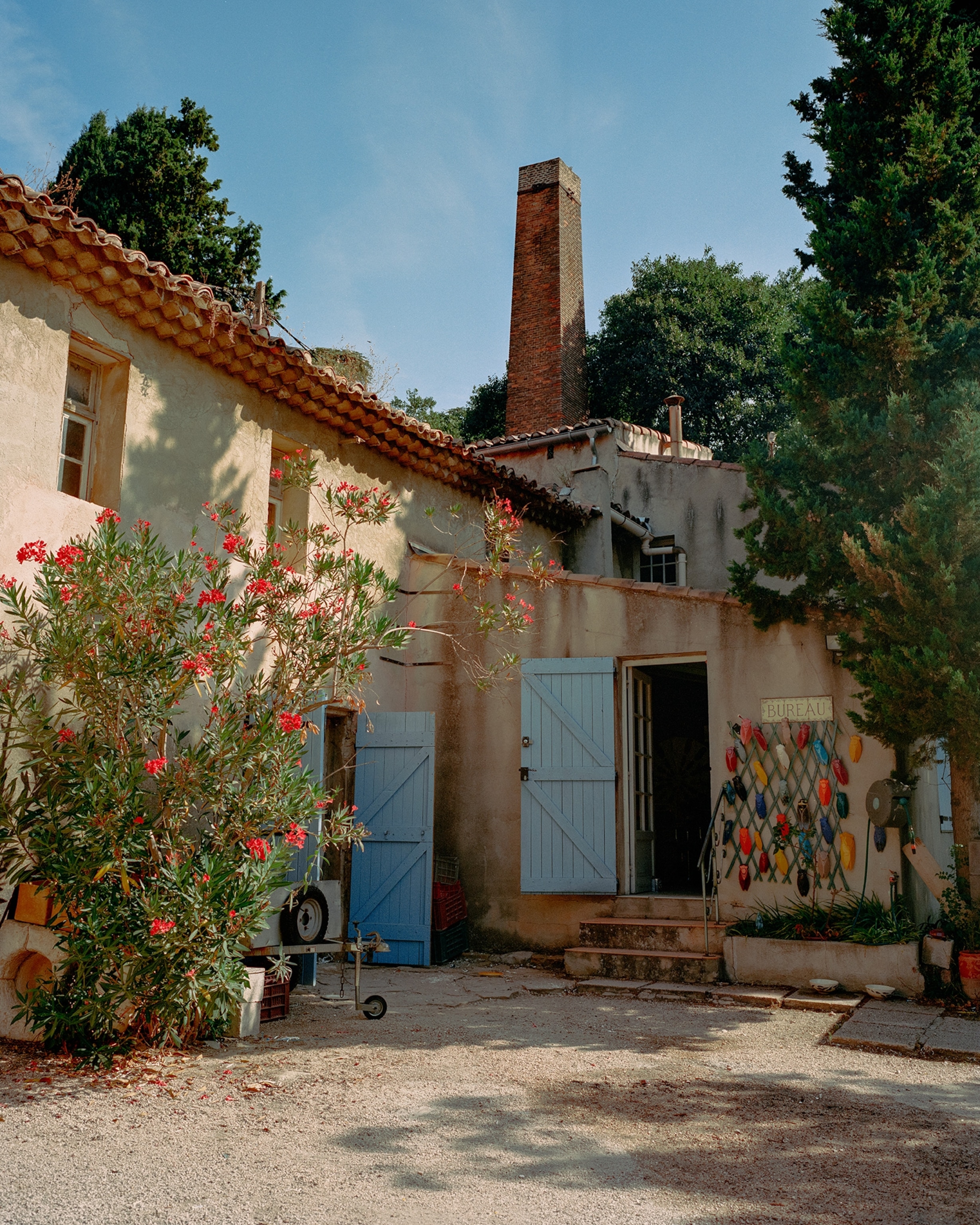 The facade of Louis Sicard Faïences photographed in the morning. You can see the original 19th-century chimney in the background.