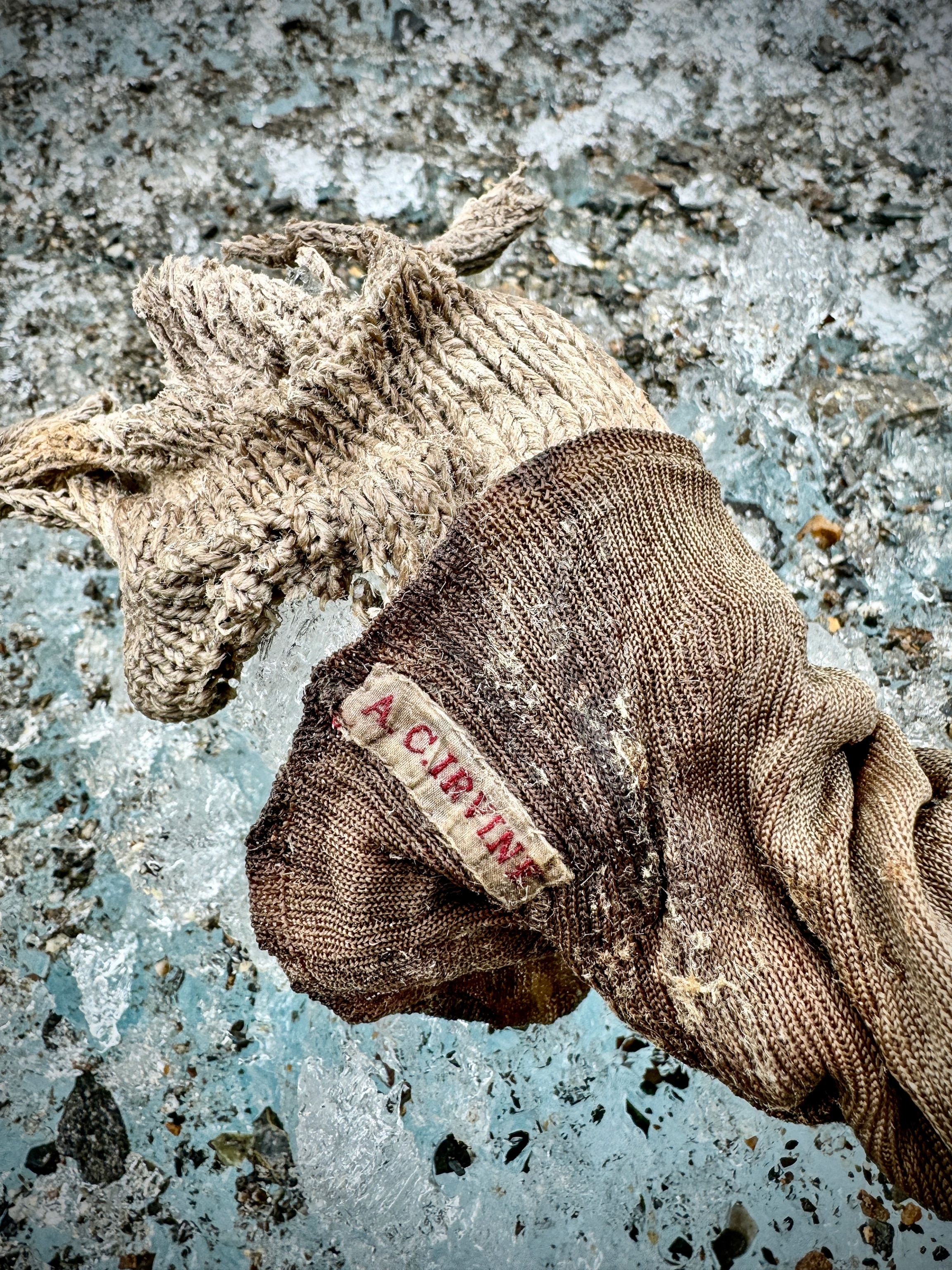 A sock emerging from the ice with Sandy Irvine's name on it