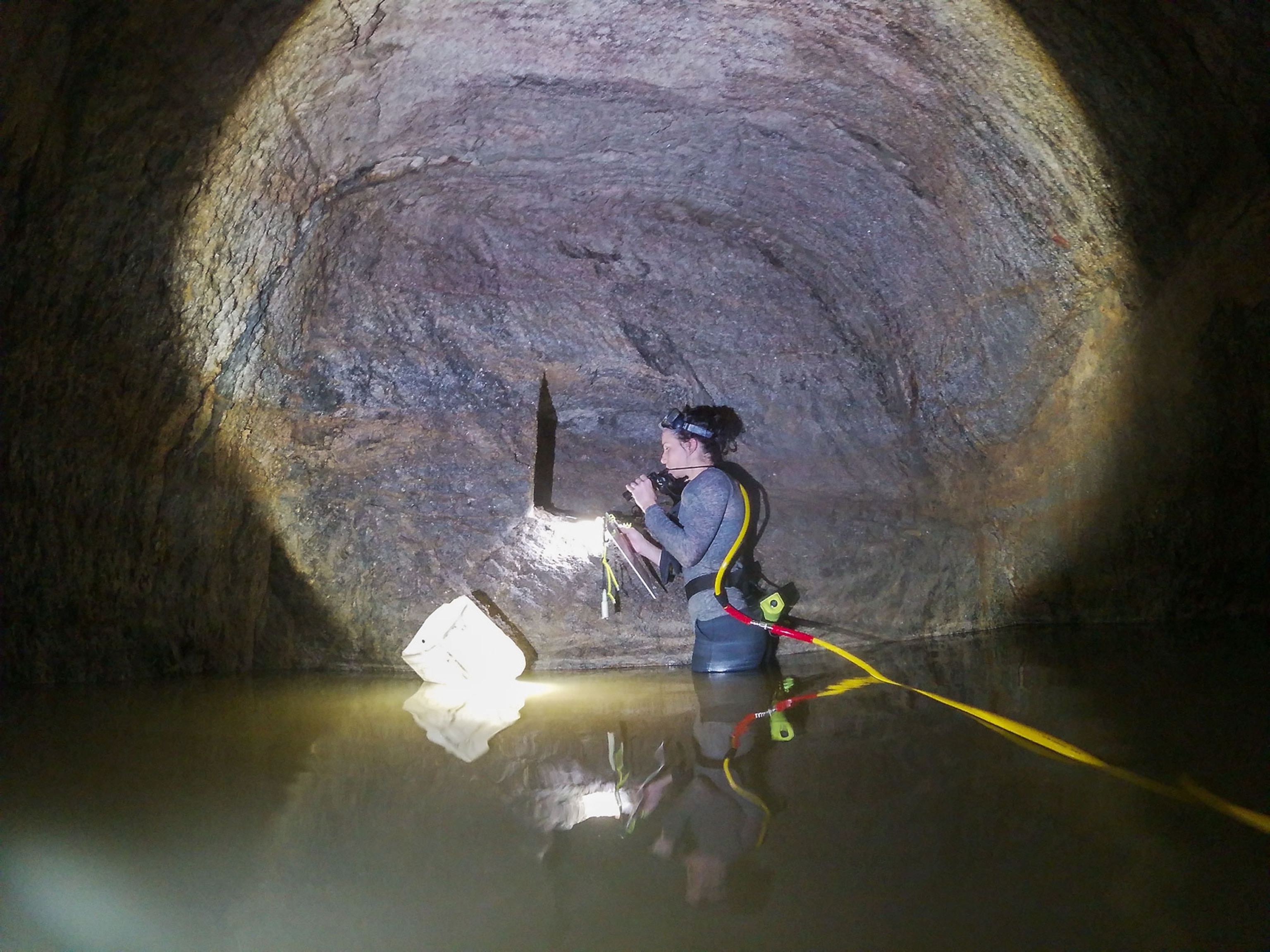 an archaeologist examining an artifact underneath a pyramid