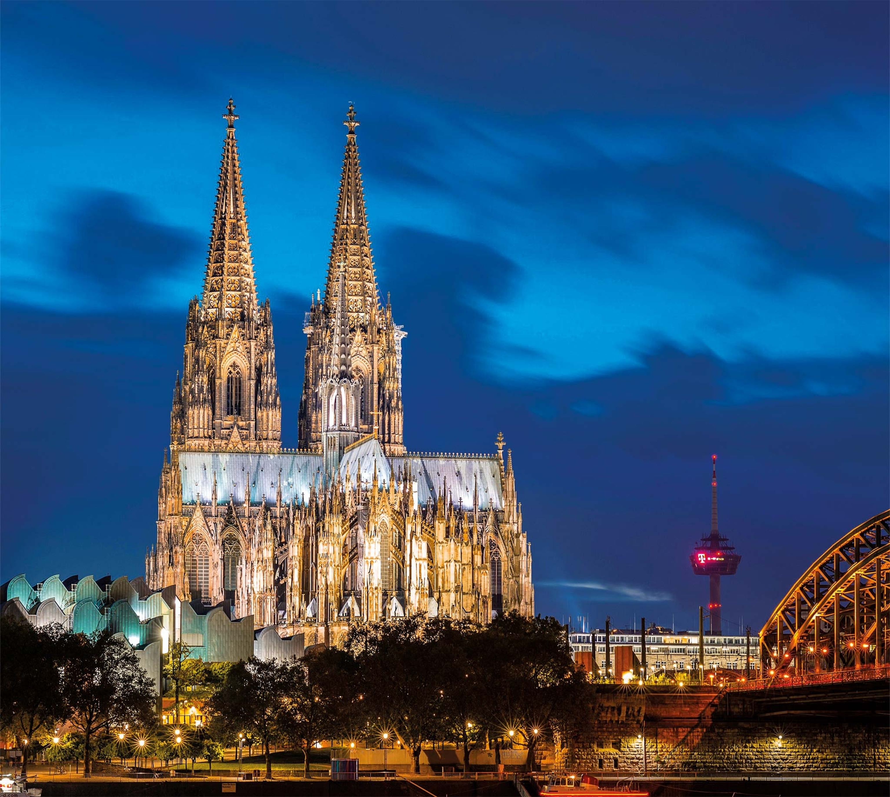 The two spires of Cologne Cathedral are pictured at night above the river