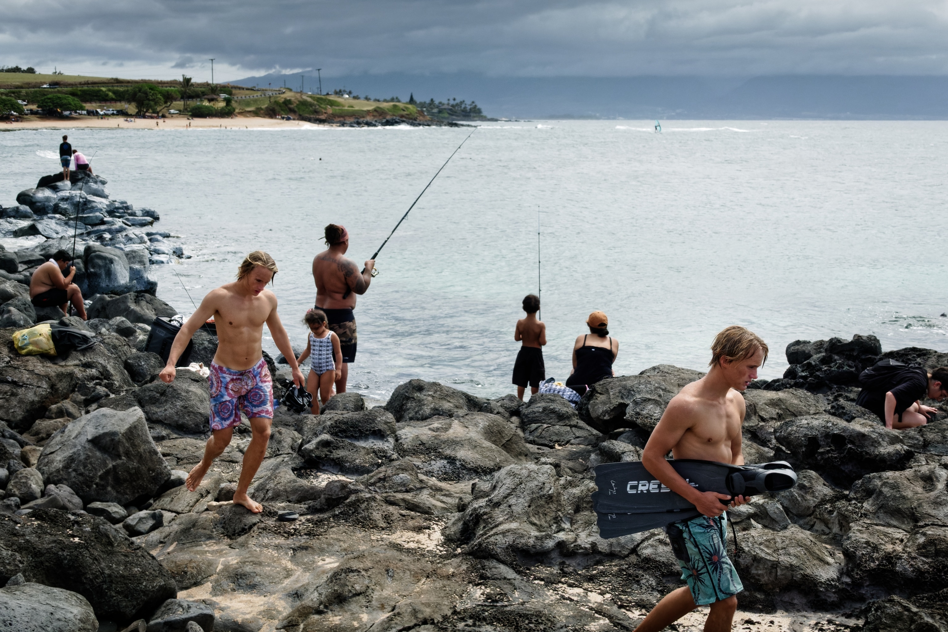 fishers and swimmers at ho'okipa beach