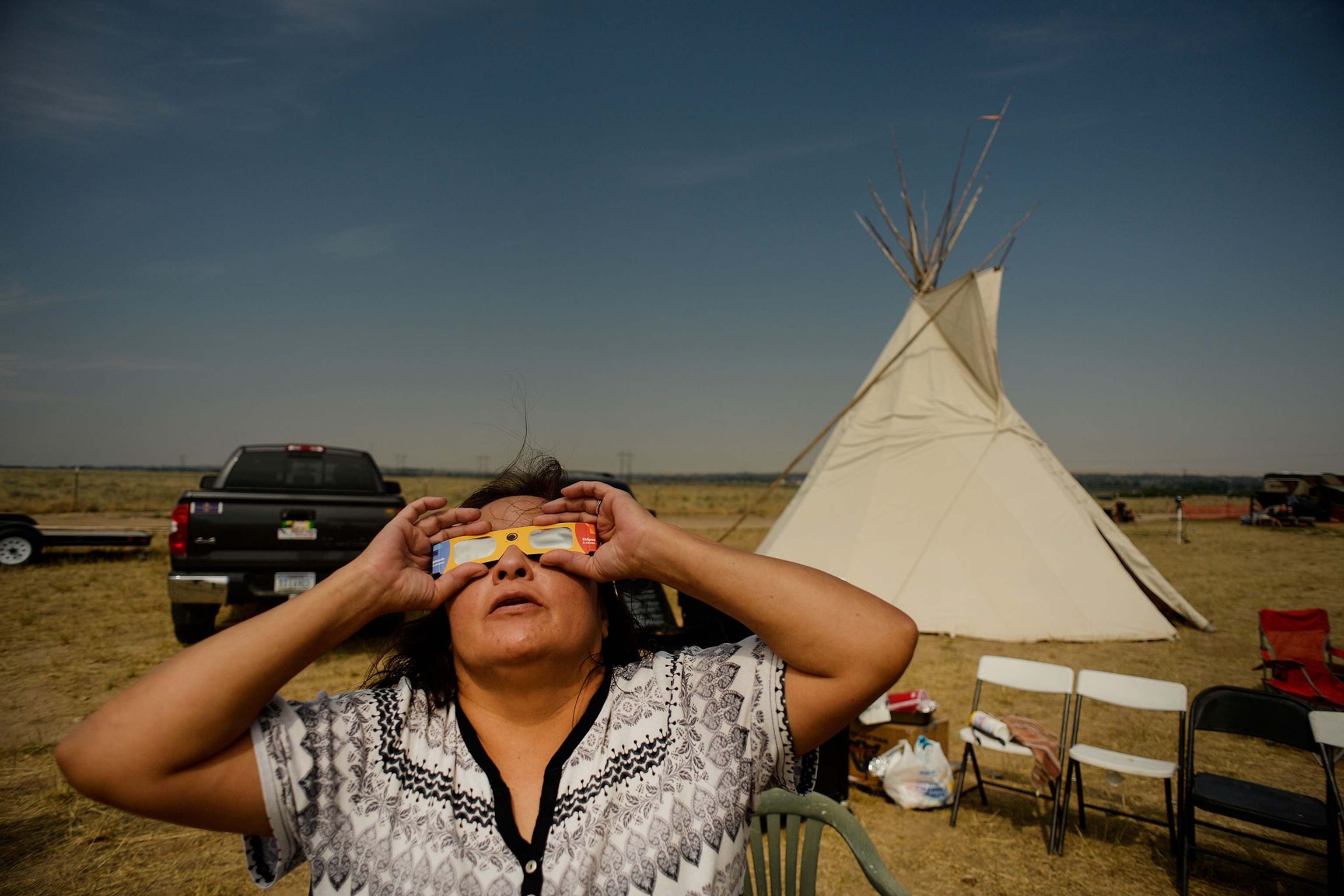 a woman looking at the solar eclipse