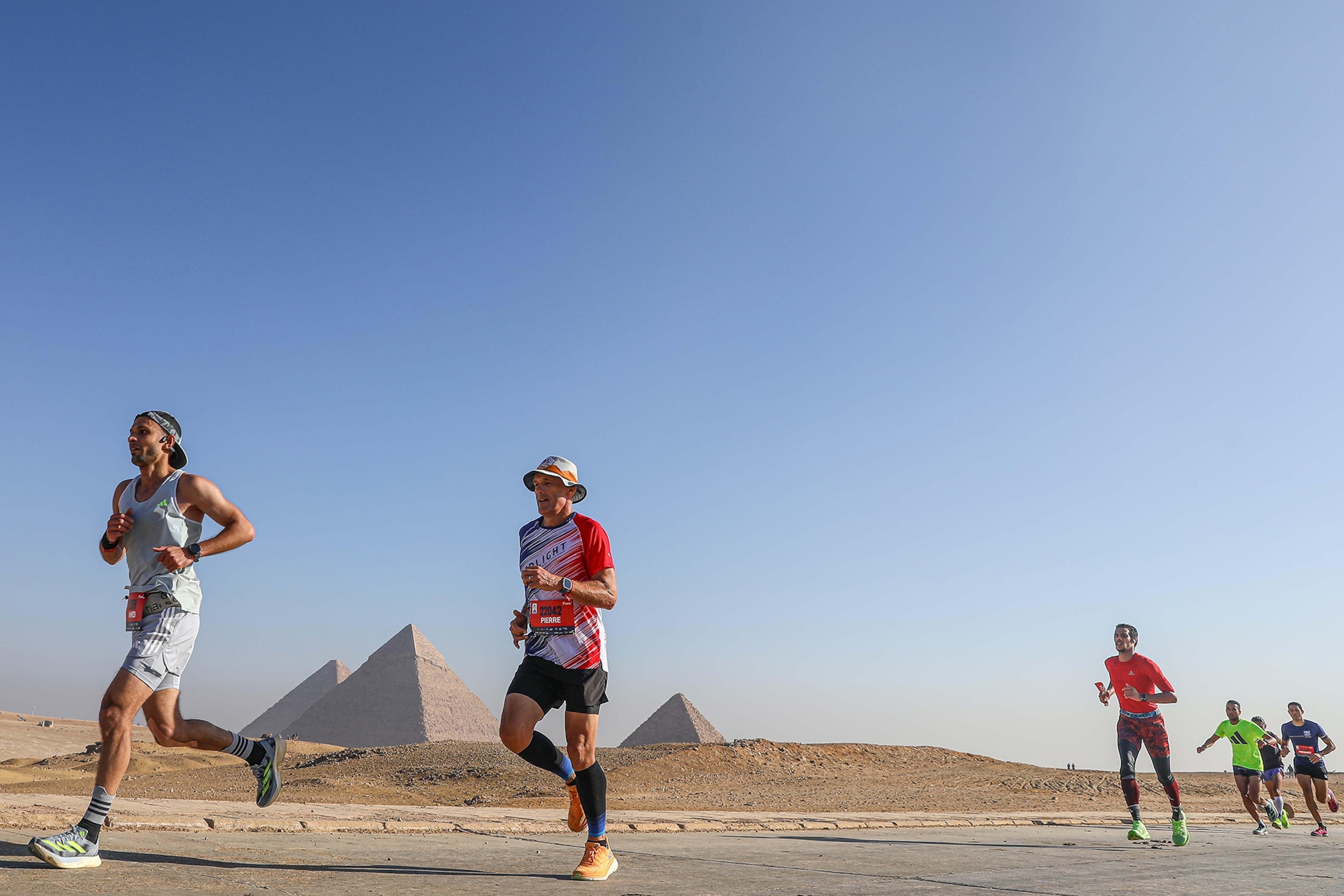 Giza, Egypt. 14th Dec, 2024. Contestants run during the Pyramids Half Marathon at the Giza Pyramids scenic spot in Giza, Egypt, on Dec. 14, 2024. Credit: Ahmed Gomaa/Xinhua/Alamy Live News